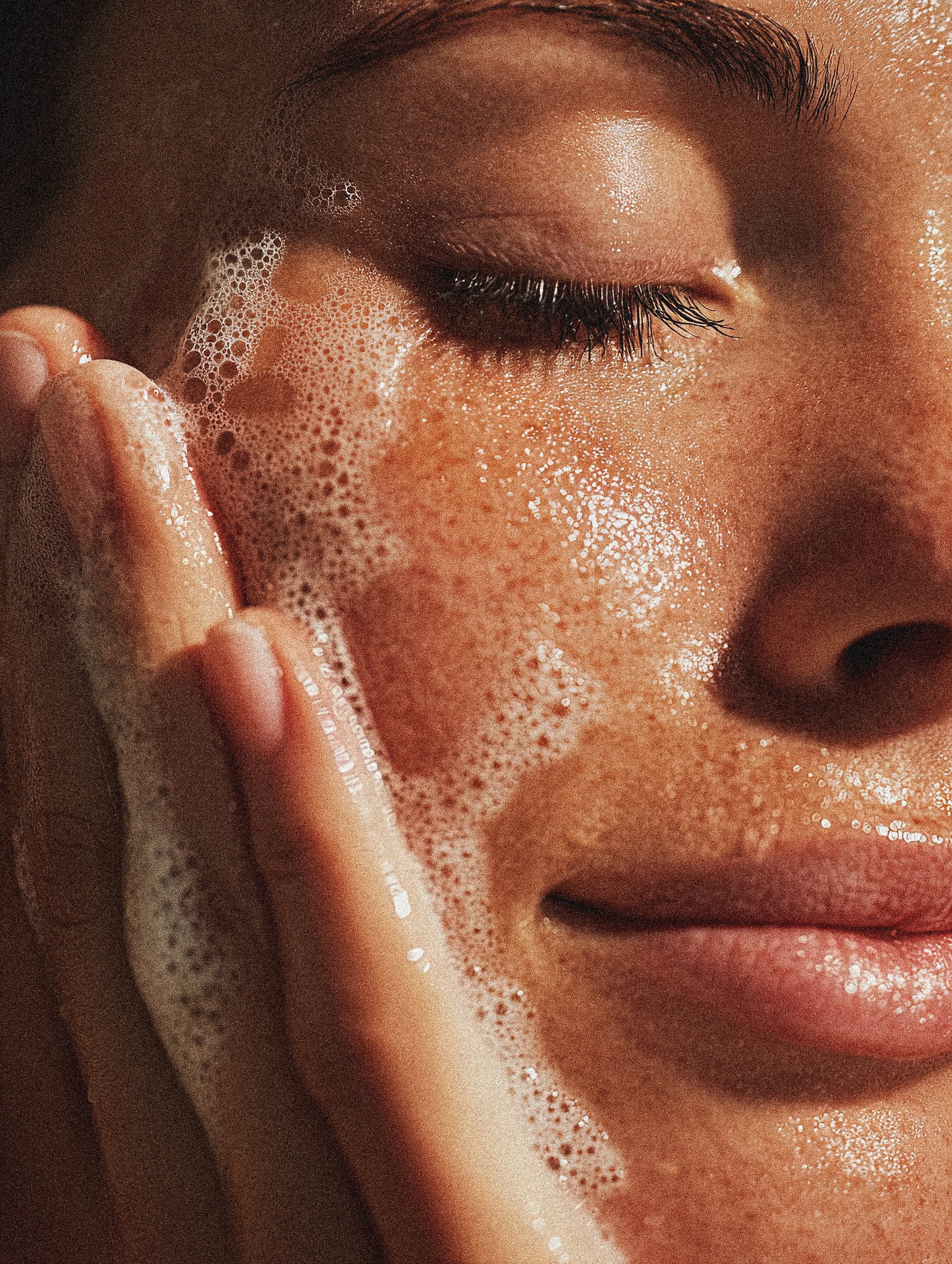 woman washing her face with sorella apothecary face wash