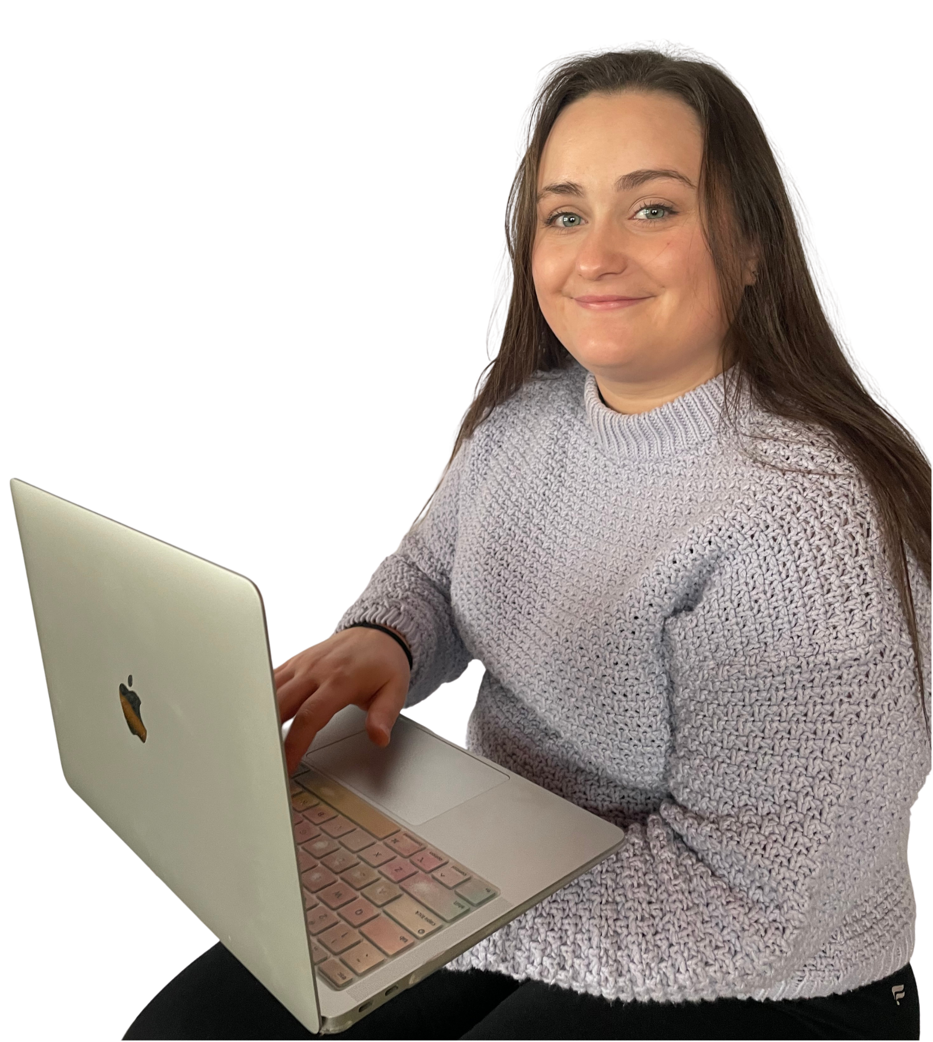 A picture of the owner and designer of Price Nine Designs sitting and working at a laptop