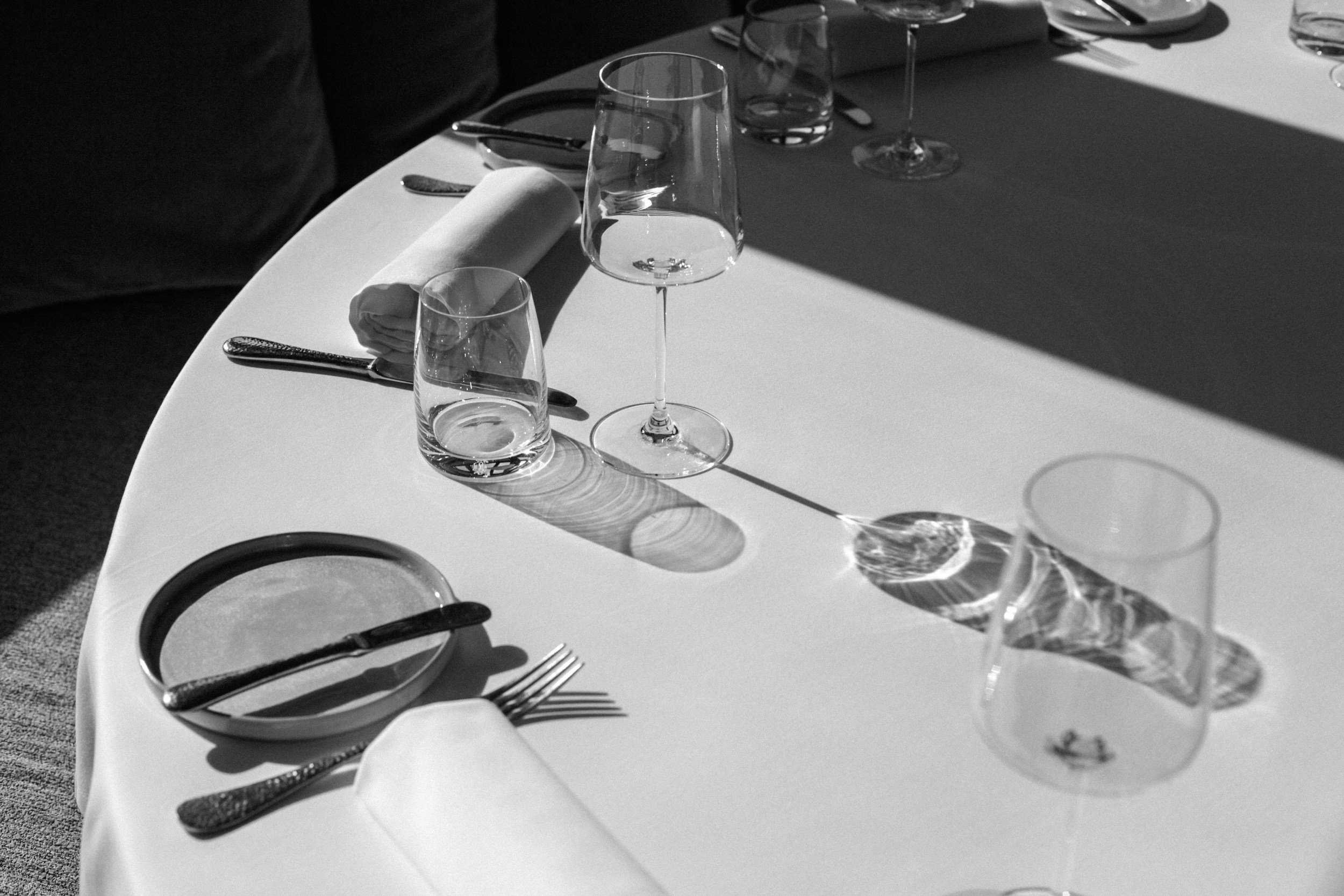 Black and white, table setting, fine dining, focus on wine glass
