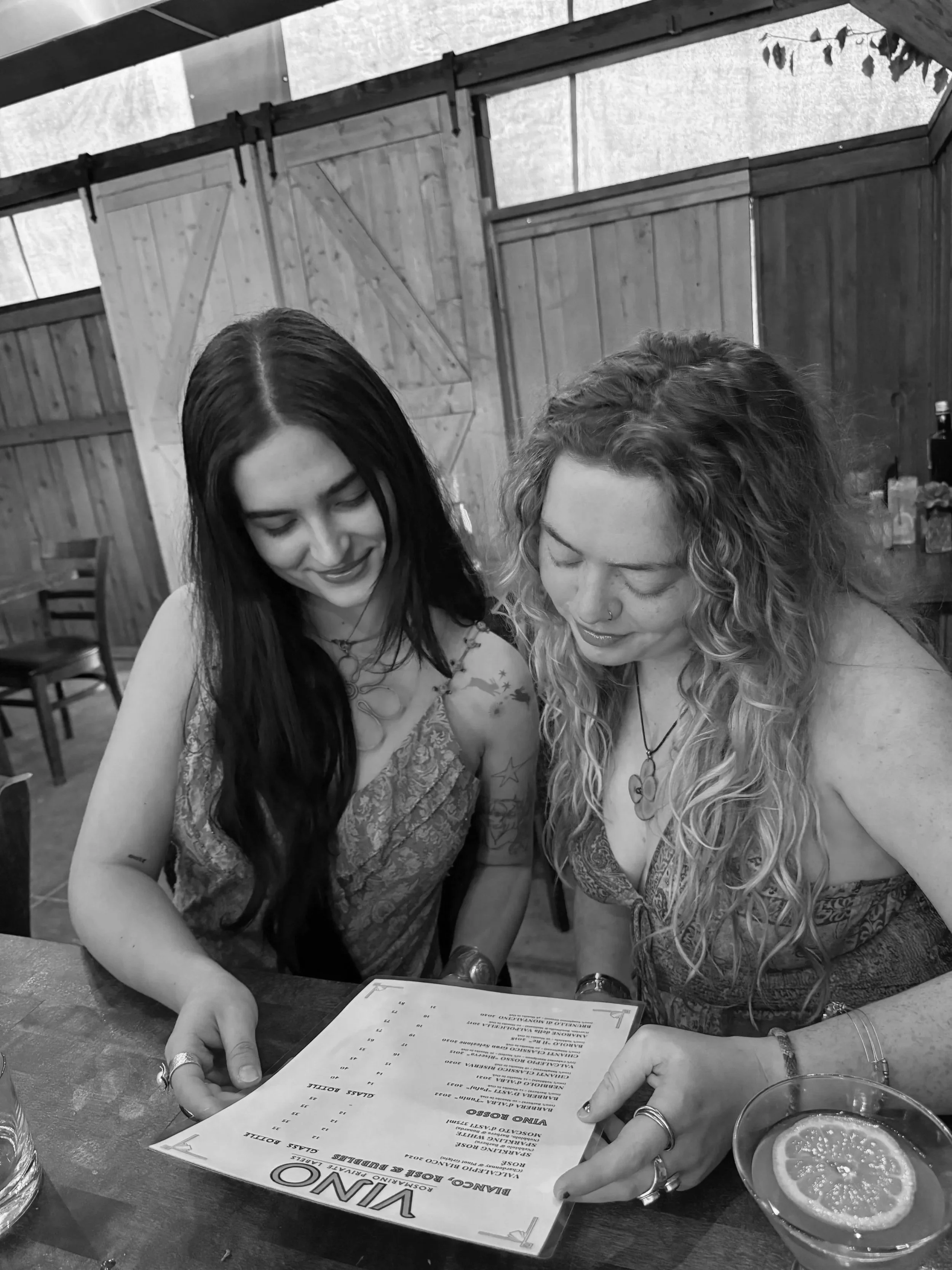 Women reading wine menu at restaurant