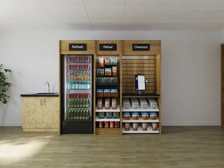 A snack and beverage station with three sections labeled Refresh, Refuel, and Checkout. The left section has a beverage fridge with bottled drinks. The middle section contains shelves with snacks and packaged food items. The right section has a digit