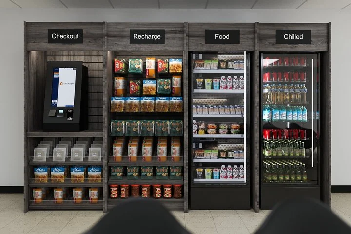 Self-service convenience store shelves with labeled sections: Checkout with an ATM-like kiosk, Recharge section with snacks and drinks, Food refrigerated section with prepared meals and snacks, Chilled drinks section with bottled beverages.