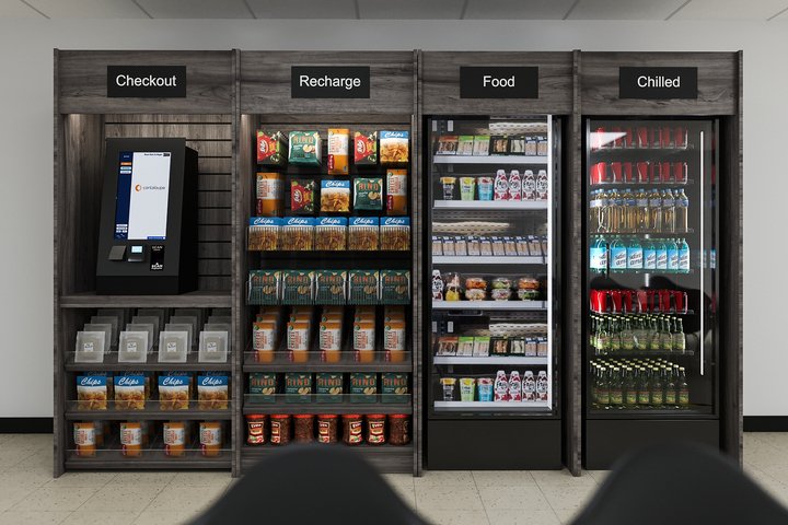 A vending machine area with four sections labeled 'Checkout,' 'Recharge,' 'Food,' and 'Chilled.' The 'Checkout' section has an electronic payment console, while the other sections contain snacks, beverages, and cold drinks.