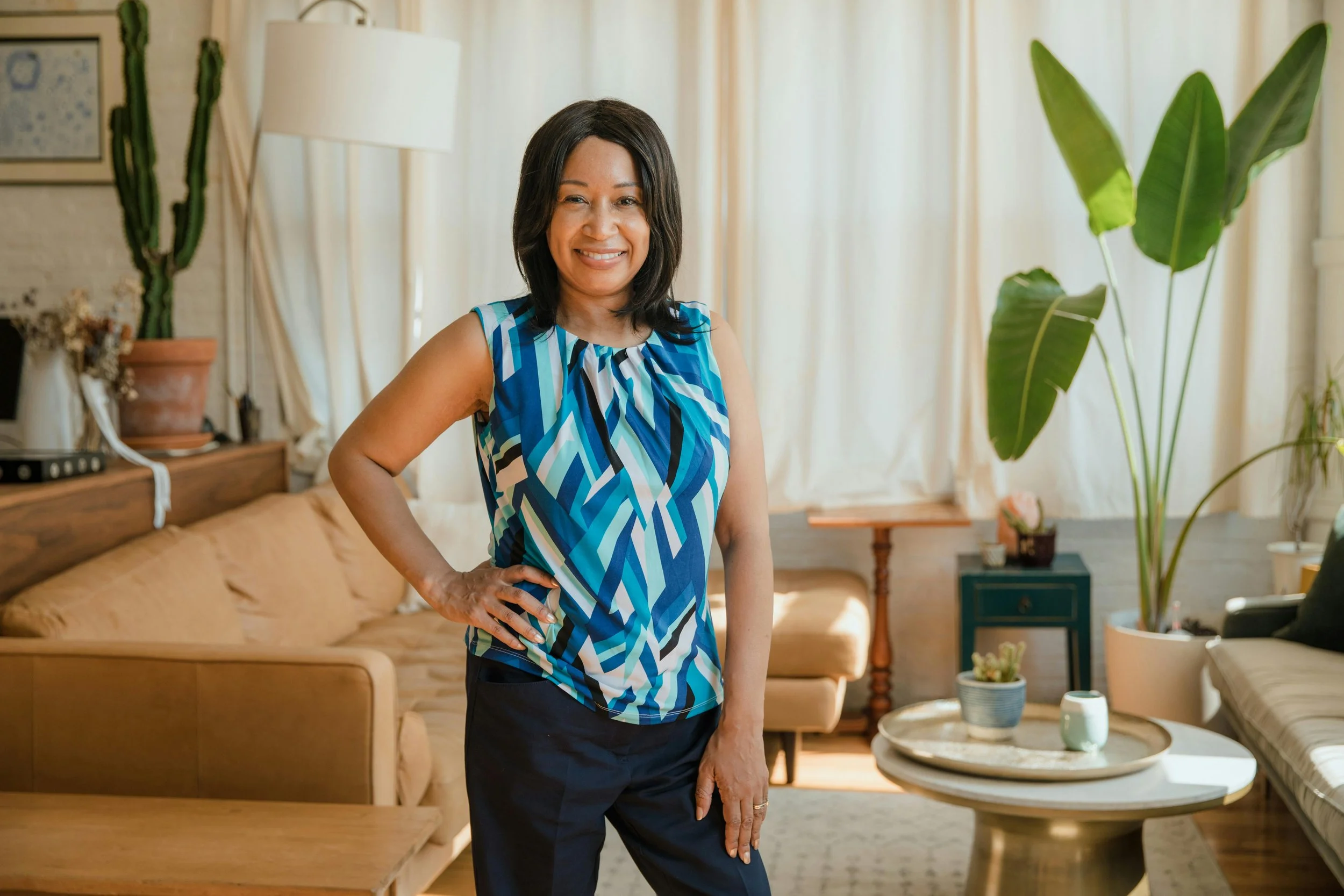 Smiling black professional businesswoman in stylish interior, embodying confidence and success. Black woman therapist Dr. Mary Woodson provides supervision in CO & NC including private practice mentorship.