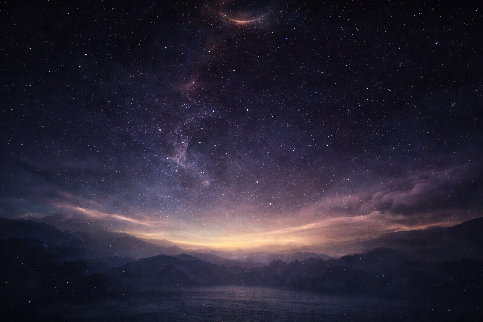 A breathtaking view of the night sky filled with countless stars and the Milky Way galaxy, with mountains and a body of water in the foreground under a glow of light near the horizon.