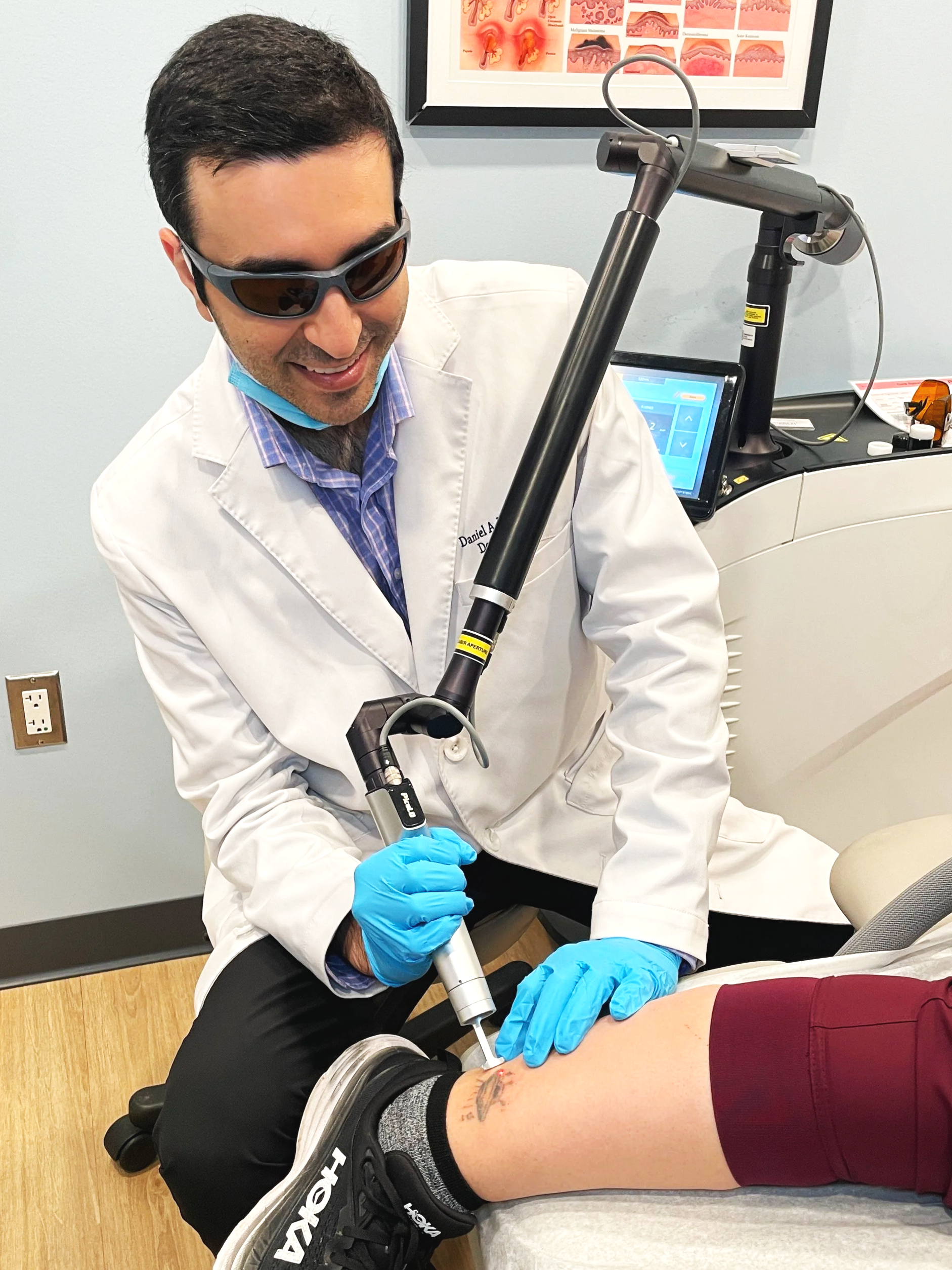 Dr. Yanes lasering a tattoo