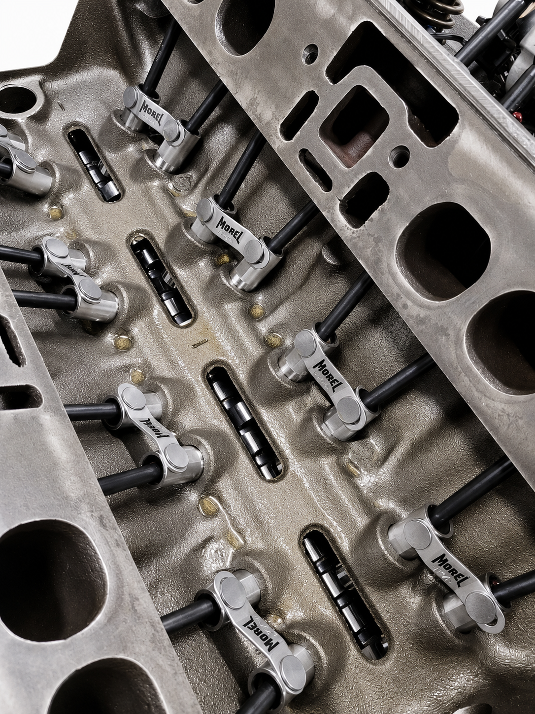 Close-up of an engine cylinder head with valves, camshafts, and rocker arms installed, showing the internal engine components.