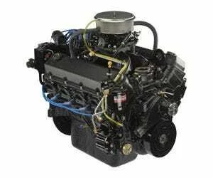 A detailed view of a bbc engine with various components, wires, and hoses visible.