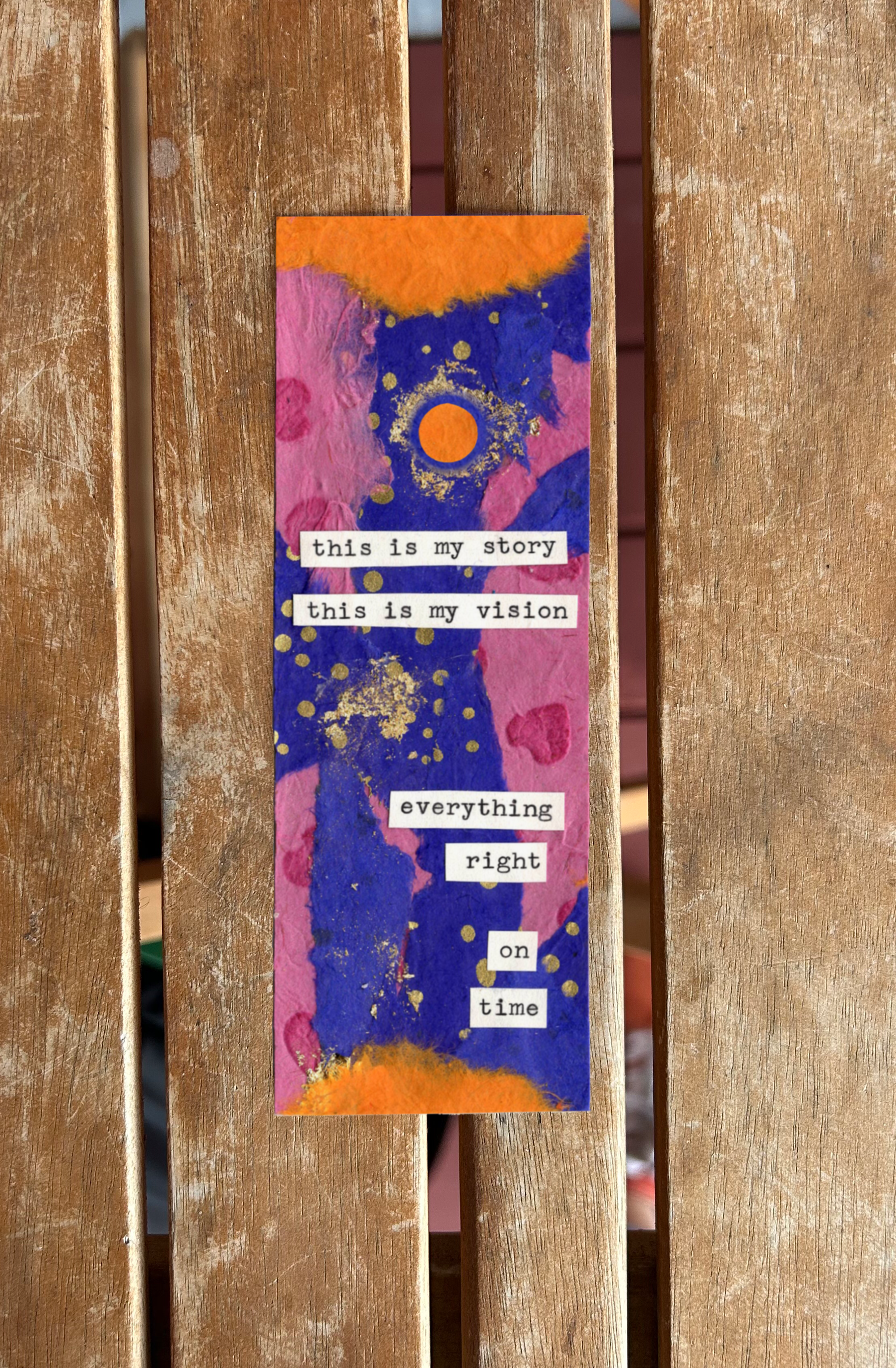 A colorful abstract painting with pink, orange, blue, and gold accents, featuring a standing vertical arrangement of white text labels that read "this is my story," "this is my vision," "everything," "right," "on," and "time".