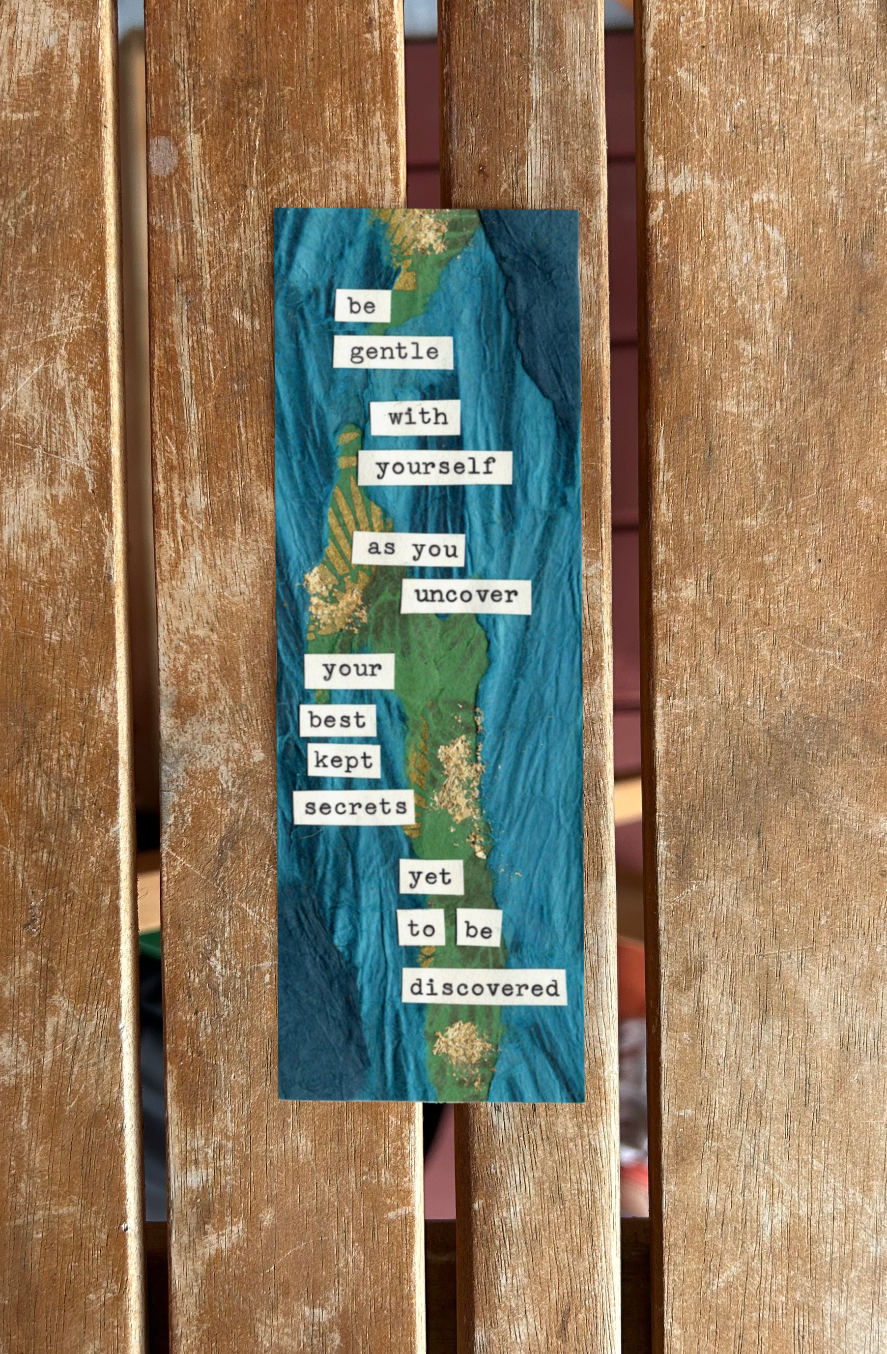 A vertical collage with a blue and green background containing a quote about kindness and secrets, with the words cut out and pasted on. The quote reads: "Be gentle with yourself as you uncover your best kept secrets yet to be discovered."