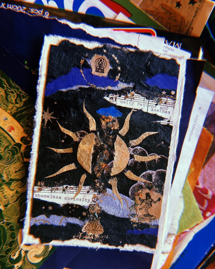 Mixed media art collage with a central sun, various celestial and mystical symbols, and torn paper elements, featuring text that reads 'the deity returns and soothes' and 'shameless curiosity'.