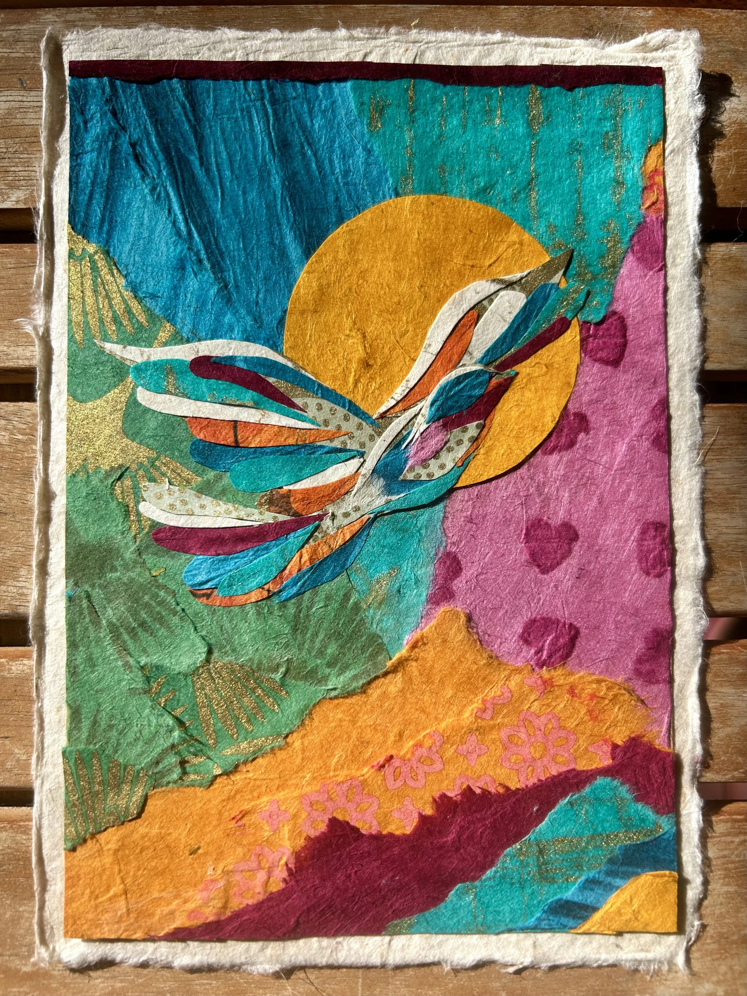 Colorful painting of a butterfly flying in front of a setting or rising sun with abstract background patterns in vibrant colors.