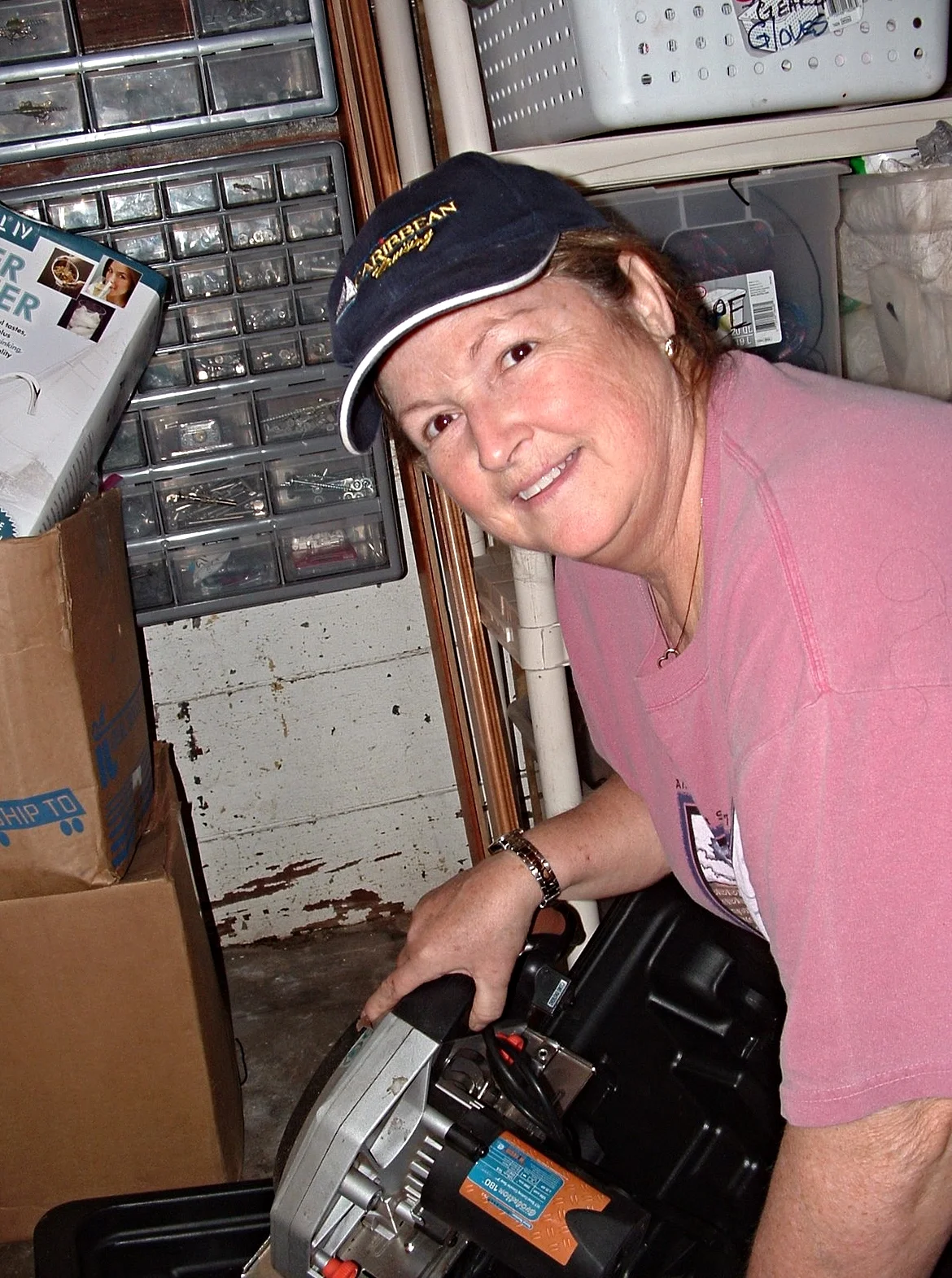 A woman using a power saw on Middle Ground Lighthouse. 