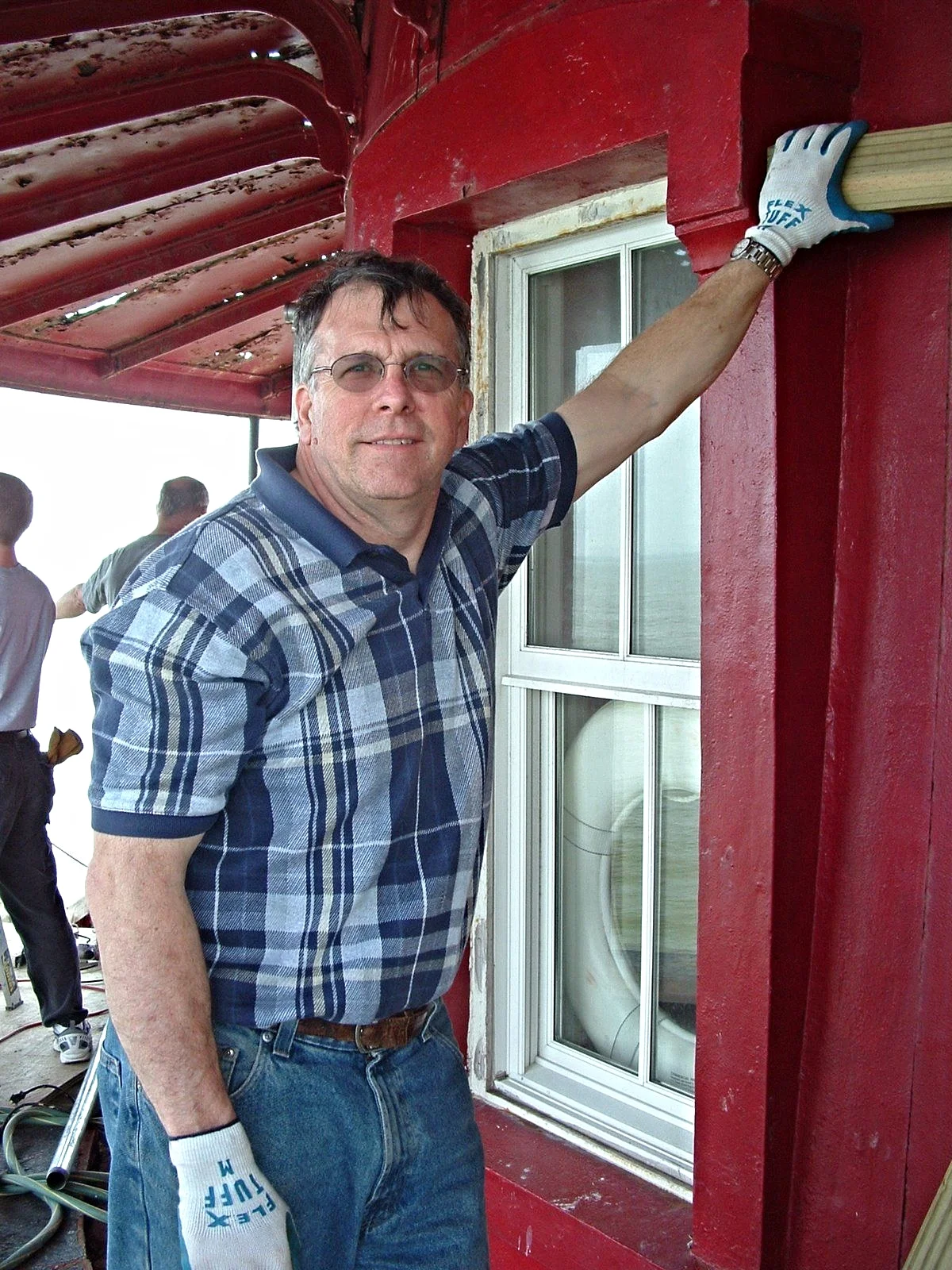 A man taking a break while renovating Middle Ground Lighthouse. 
