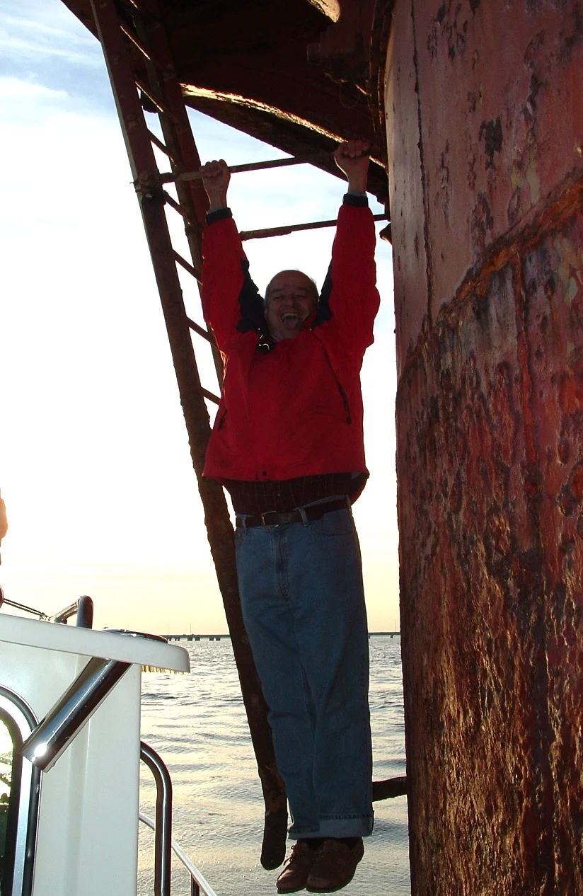 A worker on the main access ladder of Middle Ground Lighthouse. 