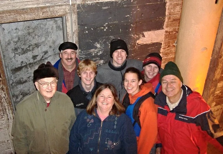 Workers on Middle Ground Lighthouse before heat was installed, wearing warm jackets and hats.