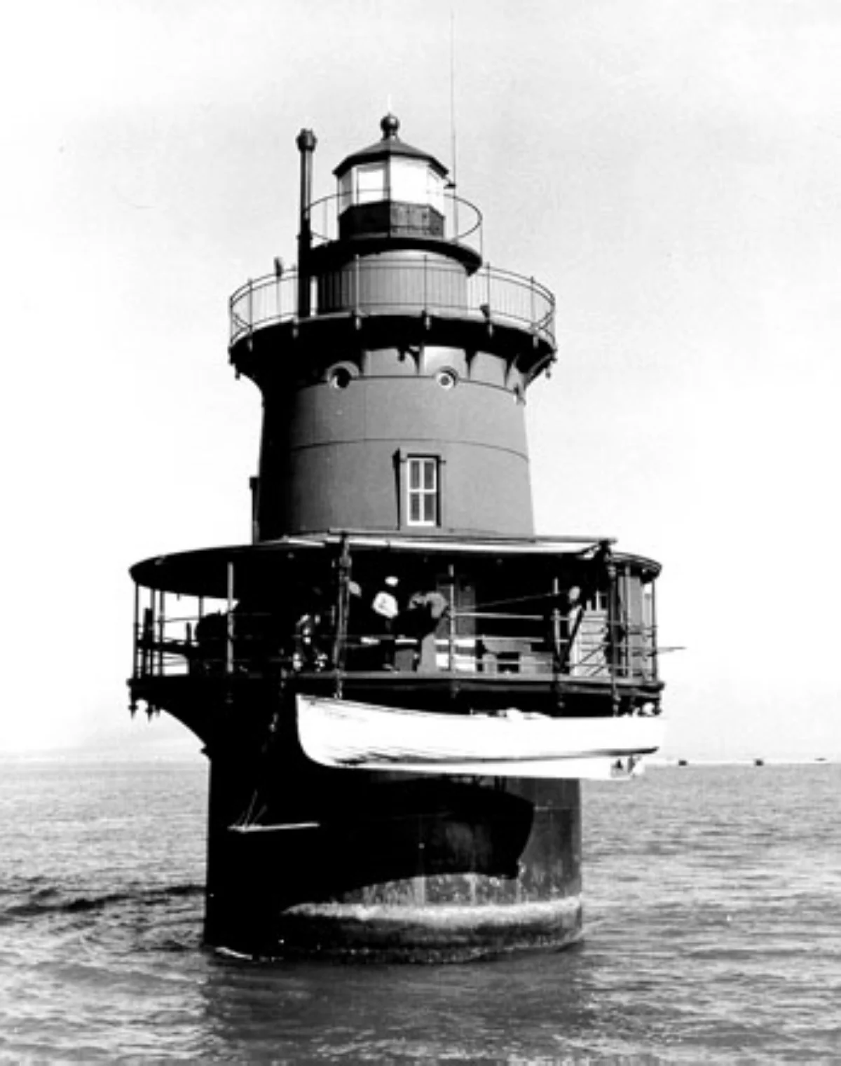 Historical black and white photo of Middle Ground Lighthouse with its boat hoisted.