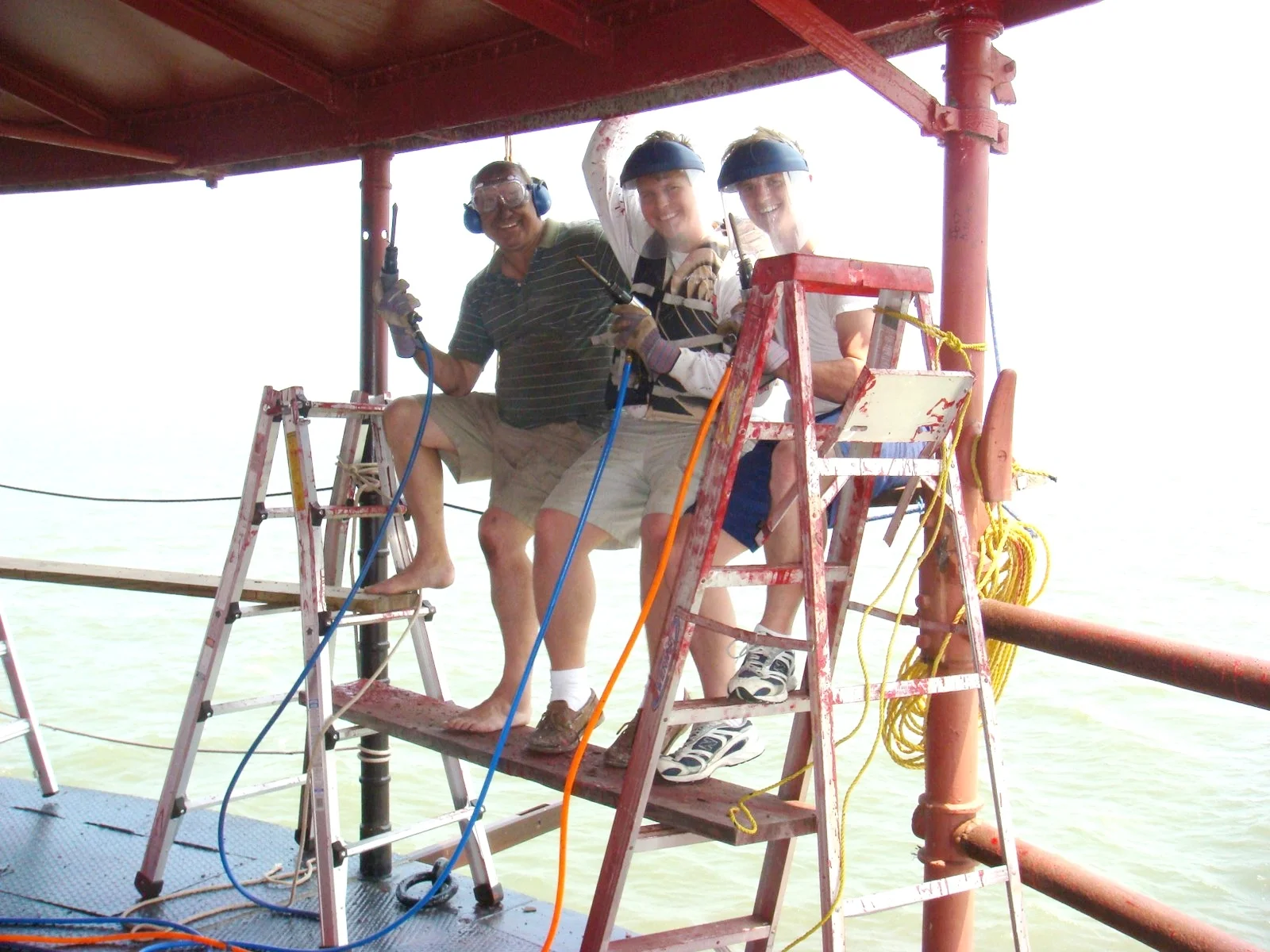 Three workers on the deck of Middle Ground Lighthouse.