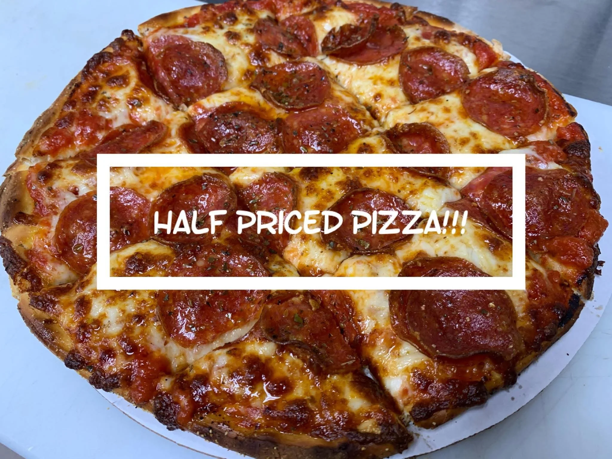 A pepperoni pizza. Text overlay states 'Half Priced Pizza!!!' in white font.