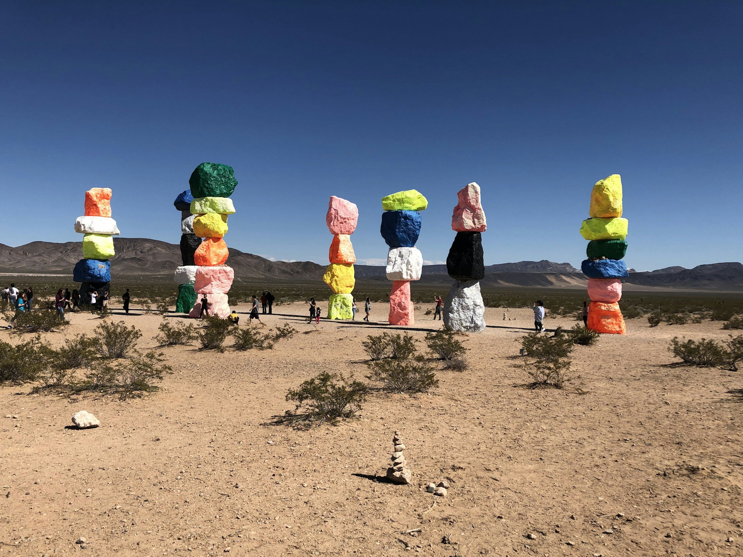 Image of Ugo Rodinone's Seven Magic Mountains Installation outside of Las Vegas. Tall, colorful rocks stacked on top of each other