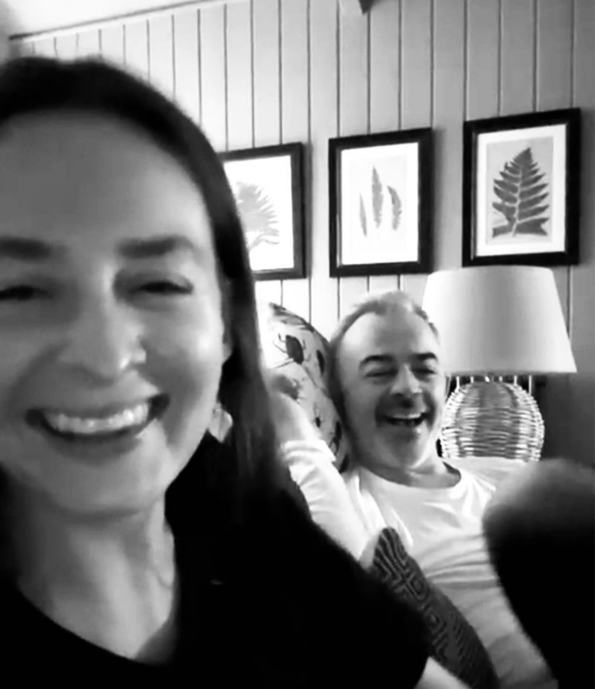 Rachelle Hicks and her partner laughing together at home in a candid moment