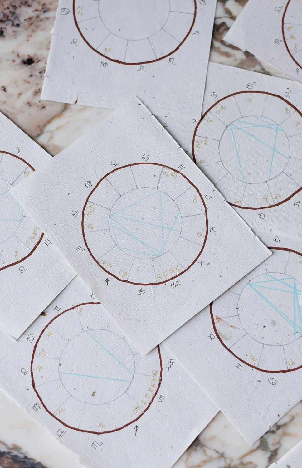 Hand-drawn birth chart readings representing the process of an astrology journey