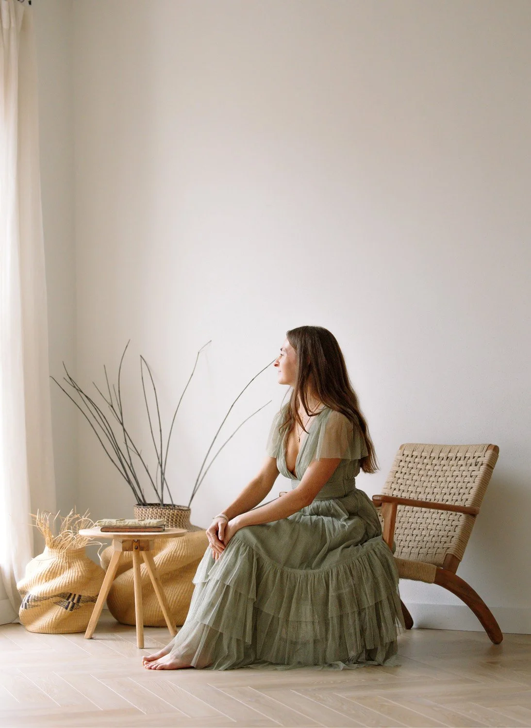 Rachelle Hicks sitting quietly by a window in contemplation