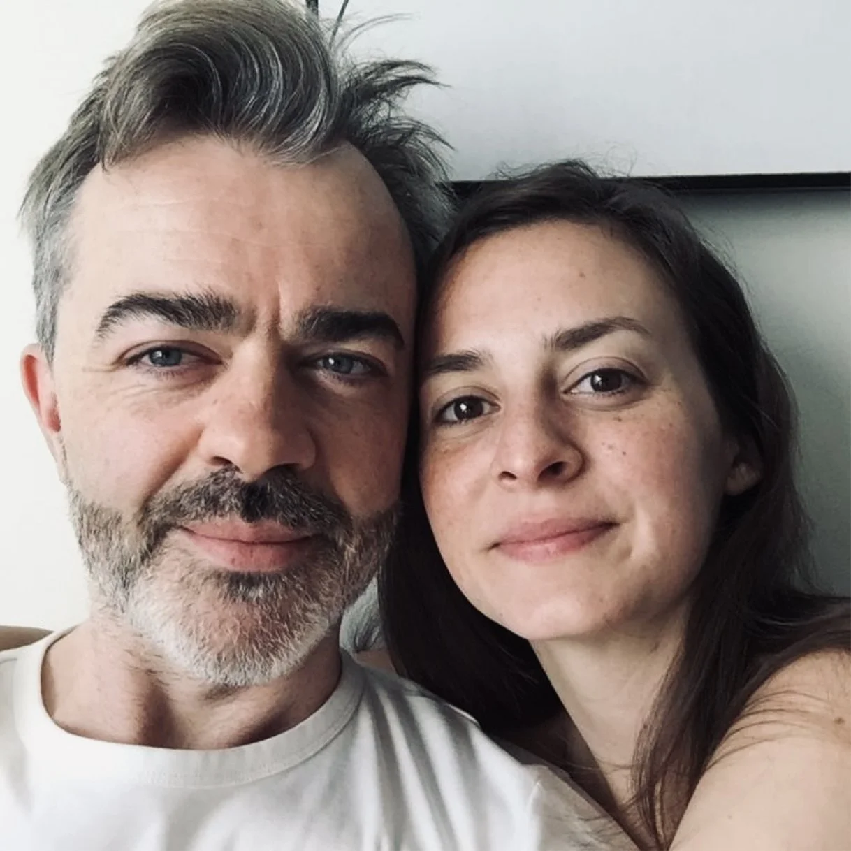 Rachelle Hicks and her partner in a close, relaxed portrait, leaning in together
