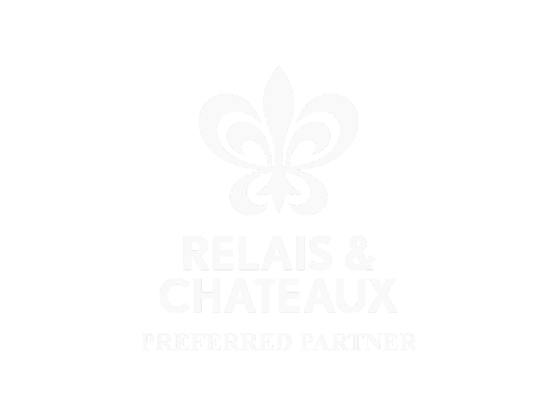 Black background with a white fleur-de-lis symbol at the top, and the text 'RELAIS & CHATEAUX PREFERRED PARTNER' below.