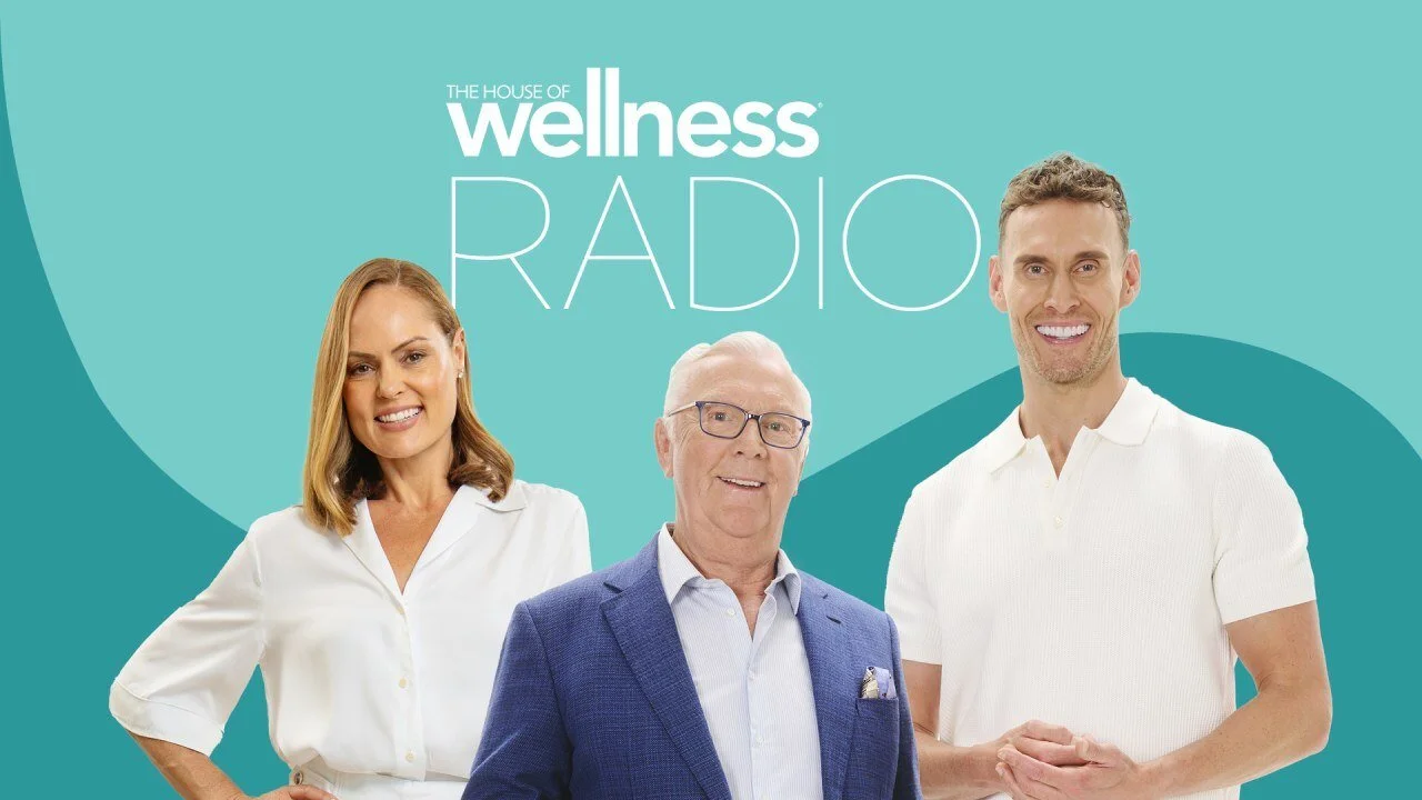 Three smiling people standing in front of a teal background with the text "The House of Wellness Radio".