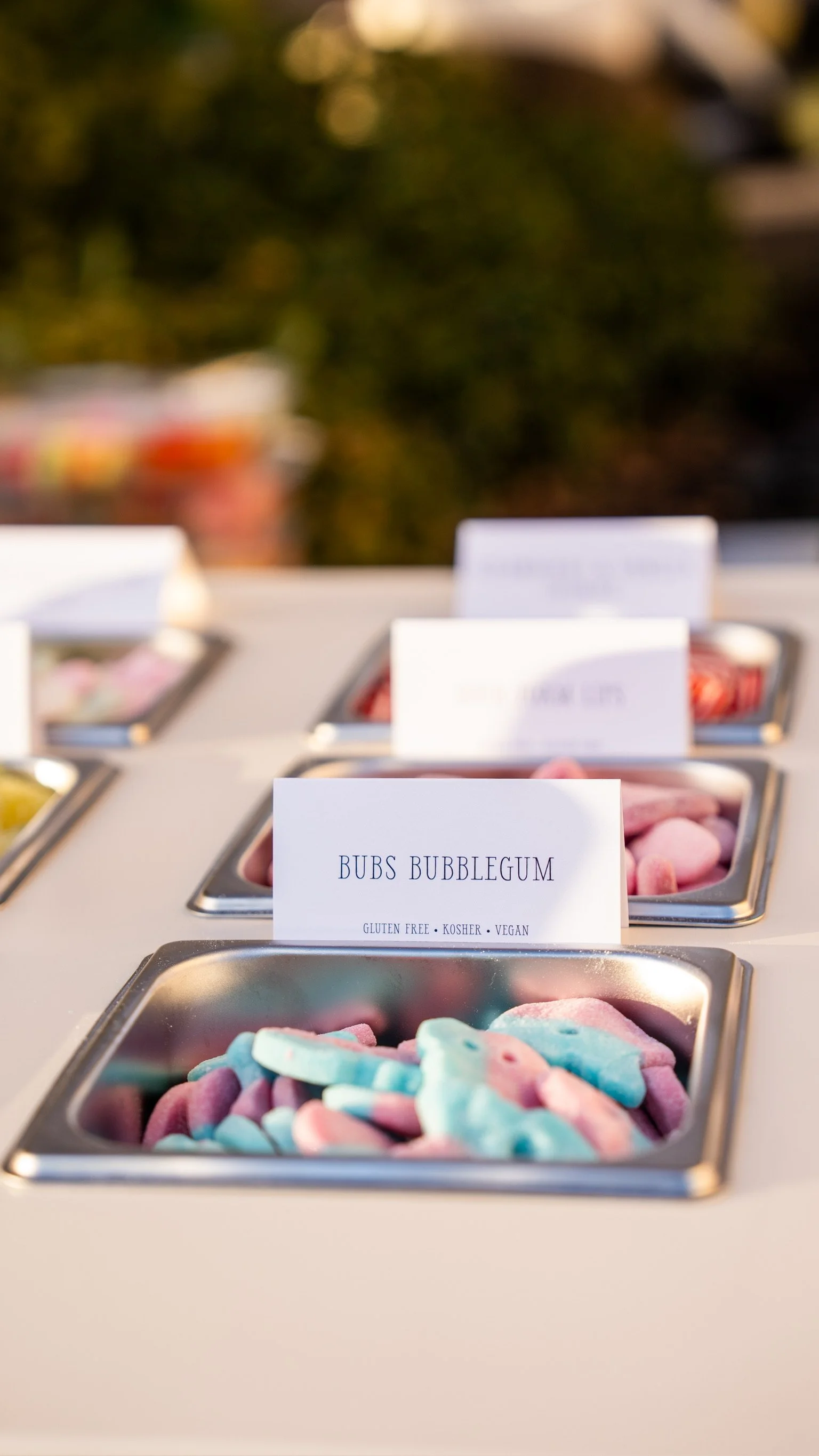 Pantry with multiple containers of colorful marshmallows labeled with different flavors, including Bubs Bubblegum