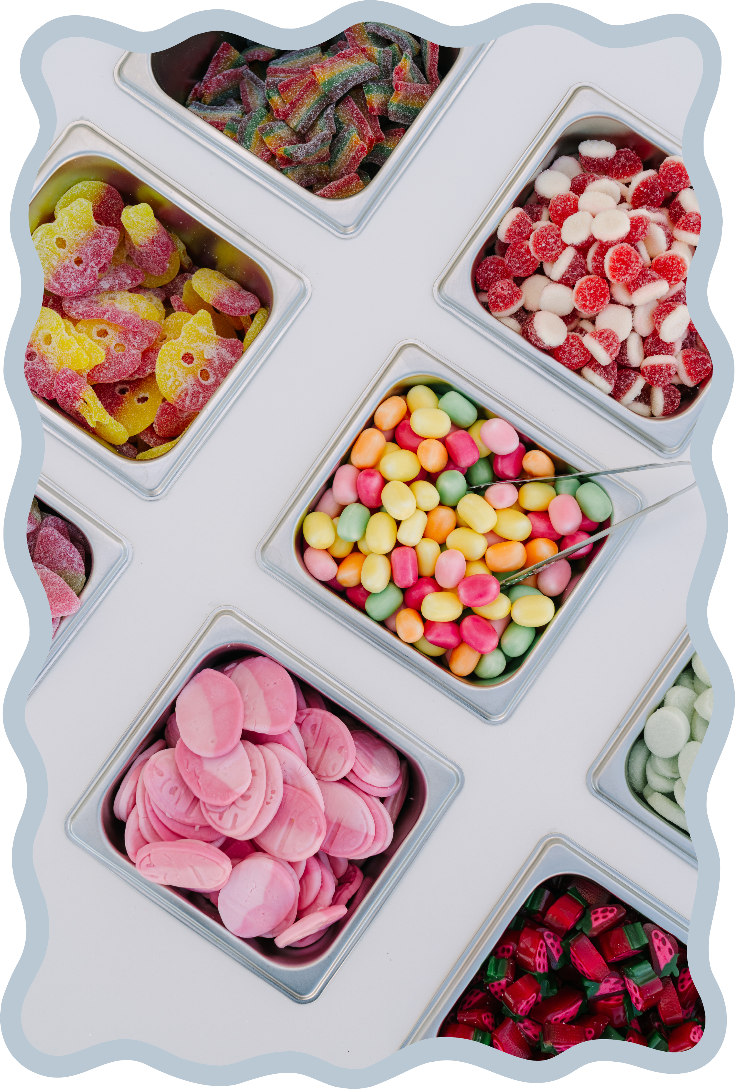 Assortment of colorful gummy candies arranged in metal containers.