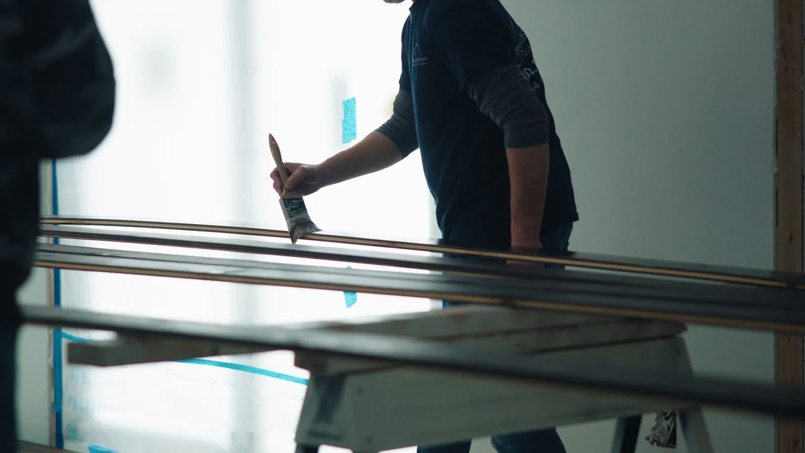 Remodeling Company in Bay Village, Ohio. Contractor working on staining a finish for primary bedroom addition.