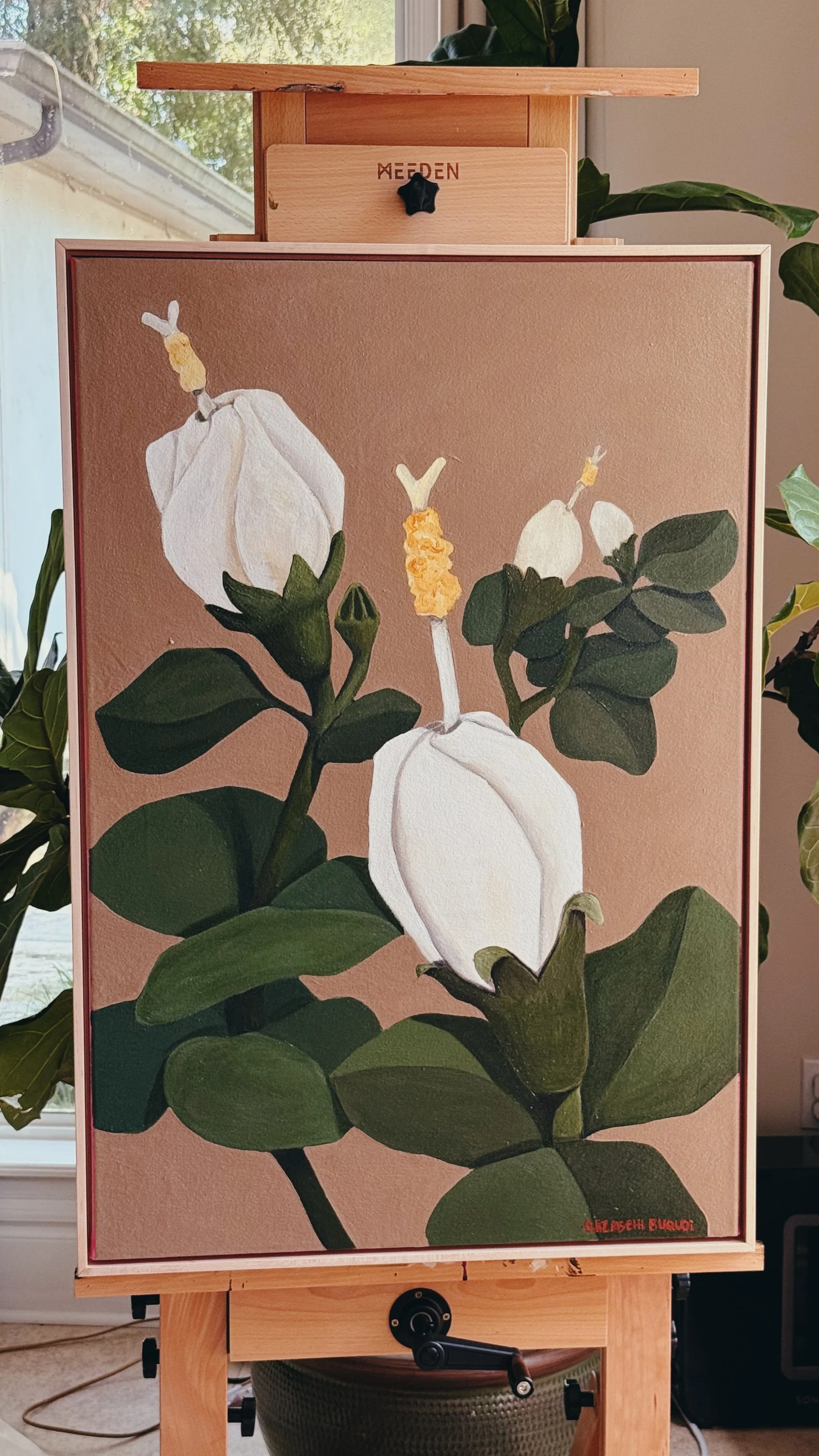 Painting of white Turk's Cap flowers with yellow centers and green leaves on a warm taupe background, displayed on an easel.