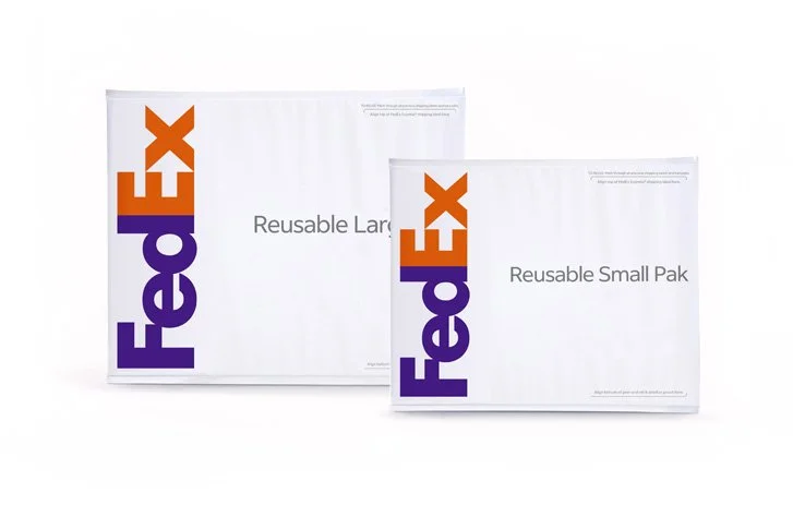 Two white FedEx reusable mailers, one large and one small, with FedEx branding and text indicating their sizes.