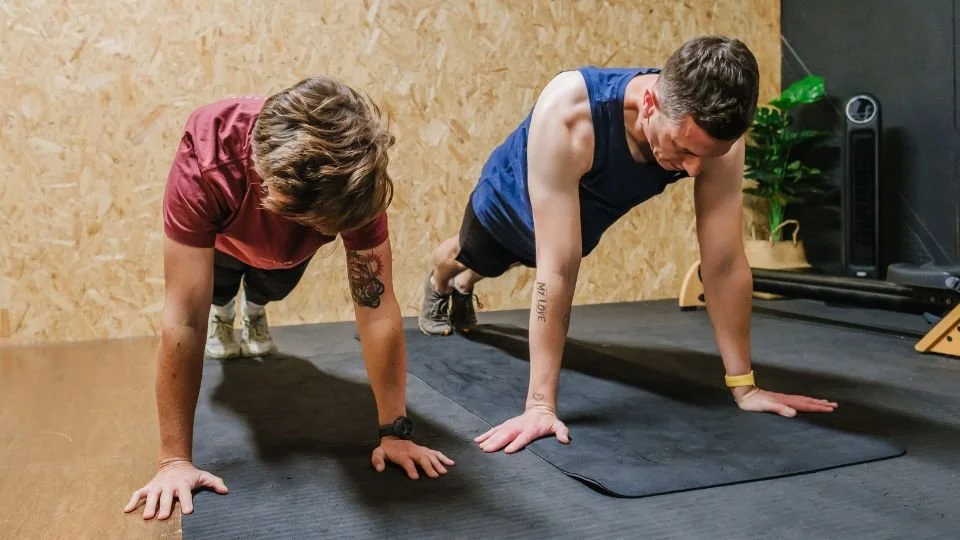 Personal Trainer demonstrating push-ups in a gym
