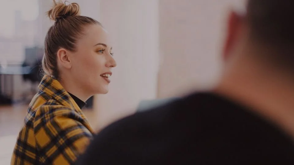 Mindset Coaching with client engaged in conversation in an office setting.