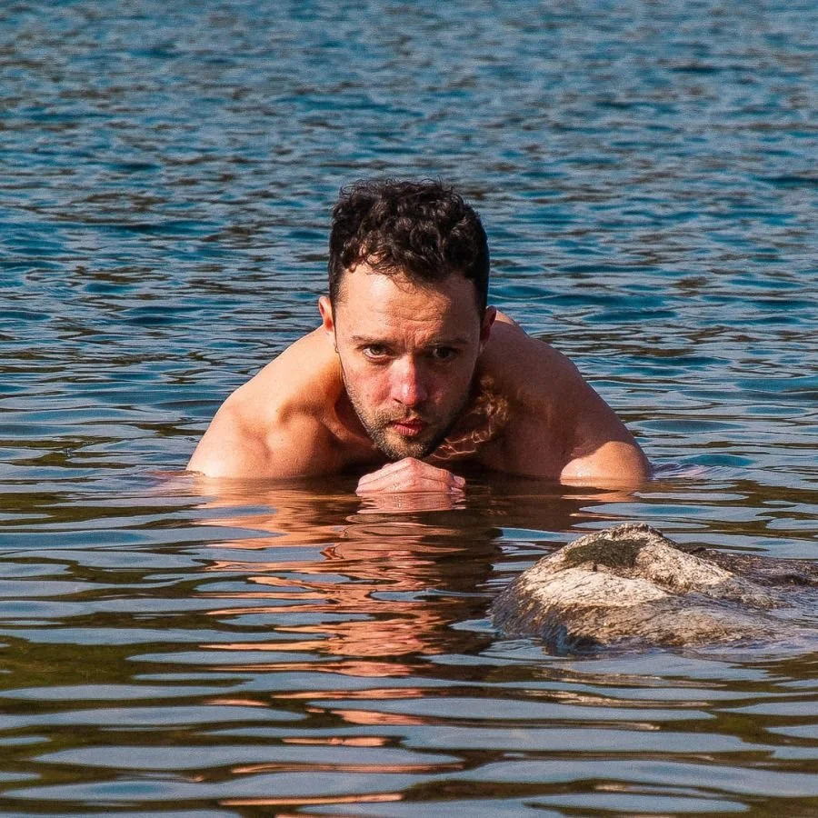 Cold Water Therapy Expert swimming in a lake with head above water