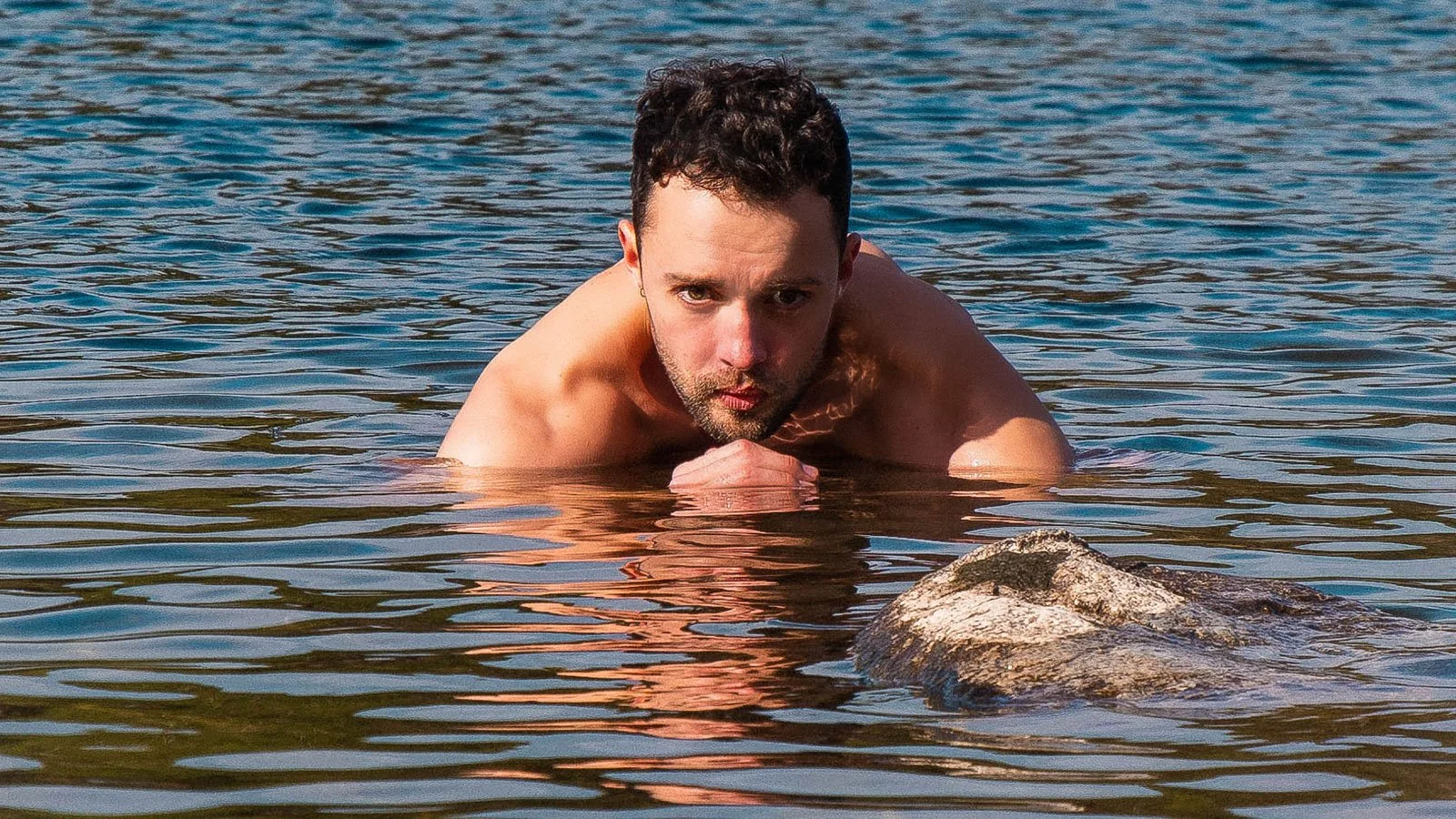 Cold Water Therapy Expert partially submerged in water, facing forward.
