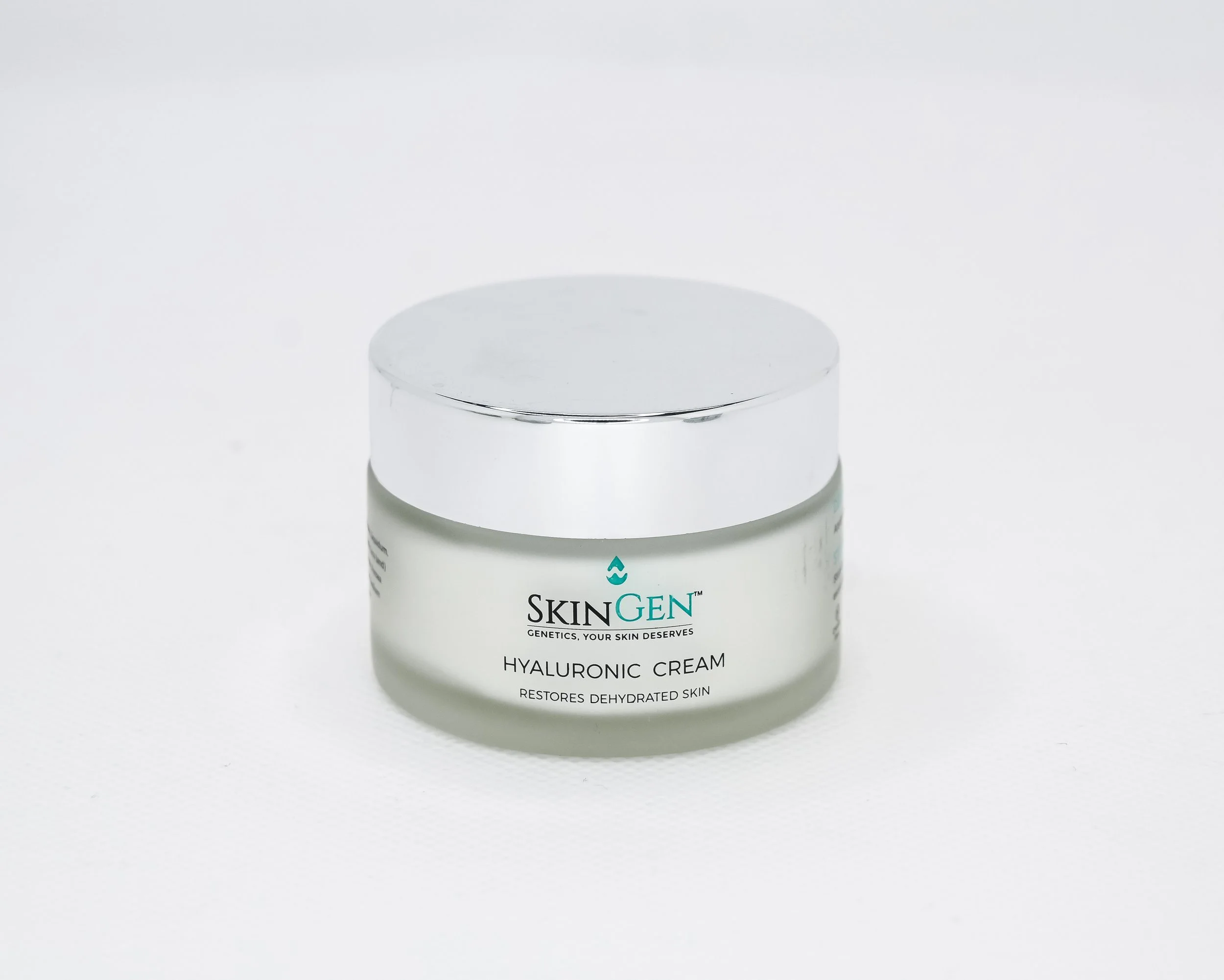 A jar of SkinGen Hyaluronic Cream with a silver lid, labeled 'Restores Dehydrated Skin,' on a white background.