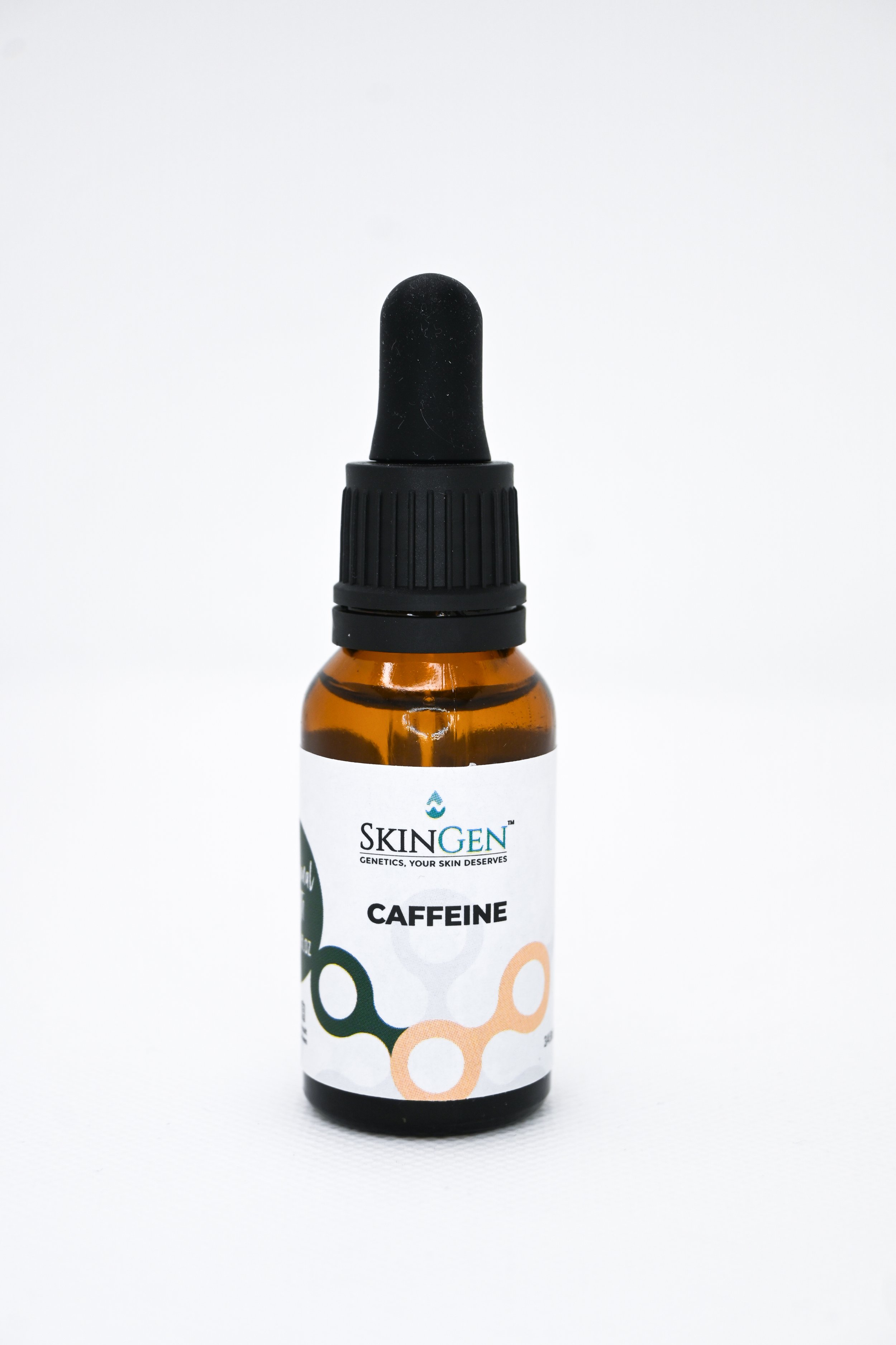 Bottle of SkinGen caffeine serum with black dropper cap against a white background.