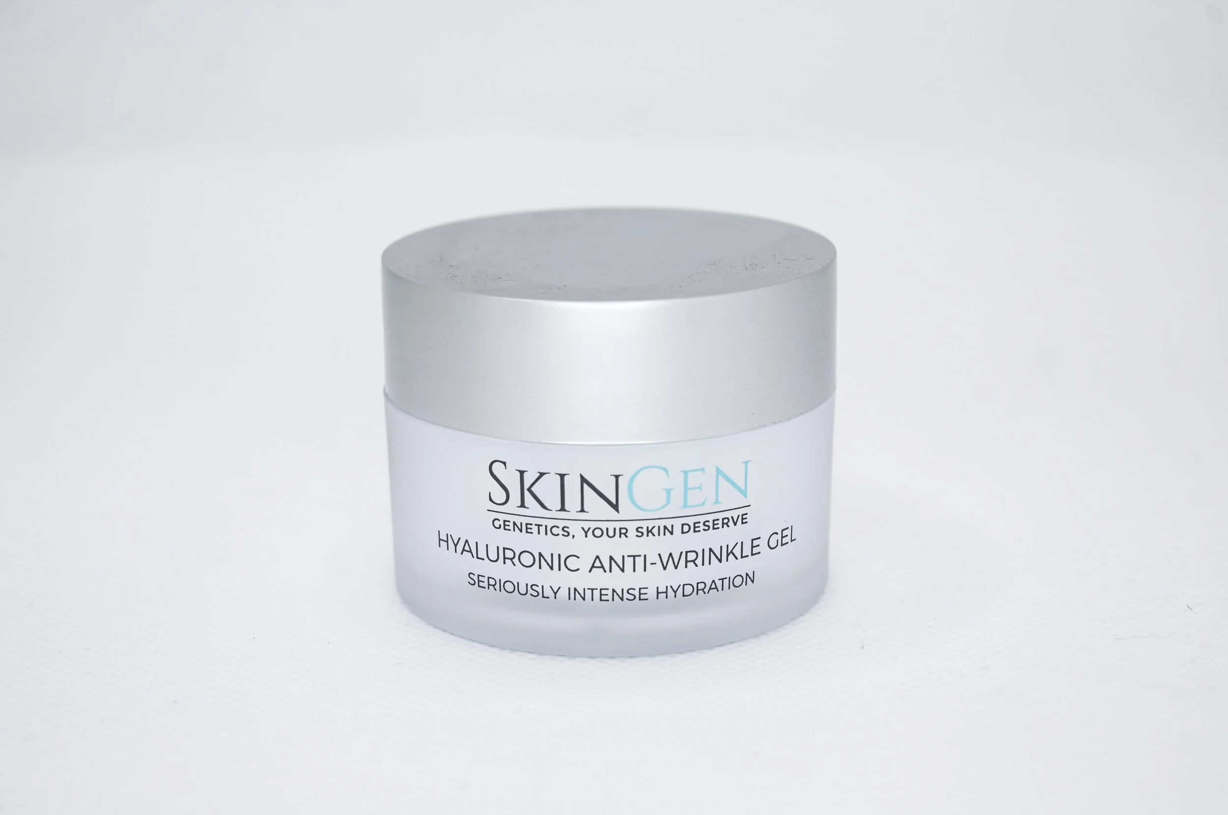 A container of SkinGen Hyaluronic Anti-Wrinkle Gel with a silver lid and white body, placed against a plain background.