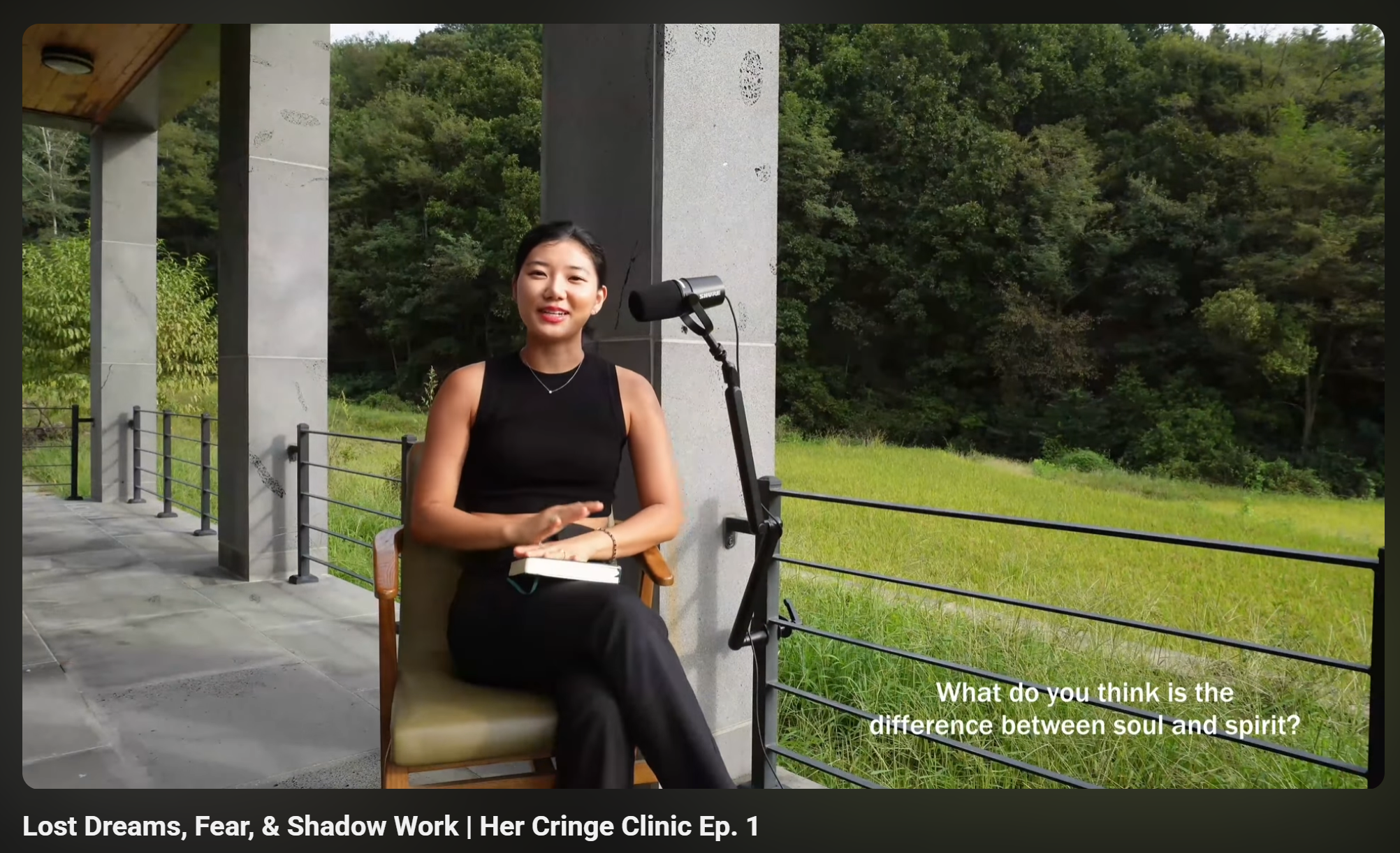 Dr. Seohyun Joo sitting outdoors in a forest, discussing "The difference between Soul and Spirit" for Her Cringe Clinic. A female psychologist with short hair speaking into a microphone. 숲속에서 '혼(Soul)과 영(Spirit)의 차이'에 대해 질문하는 주서현 박사의 유튜브 영상 스크린샷.