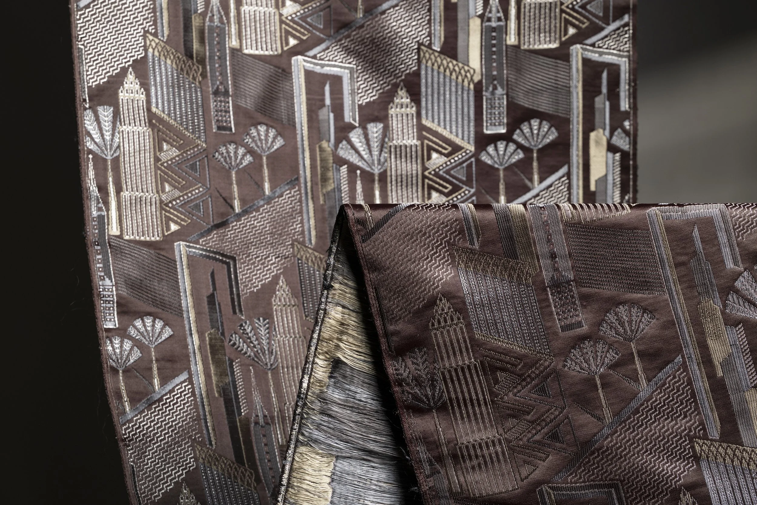 Silk brocade with woven motif and metallic thread detailing, shown in close-up.