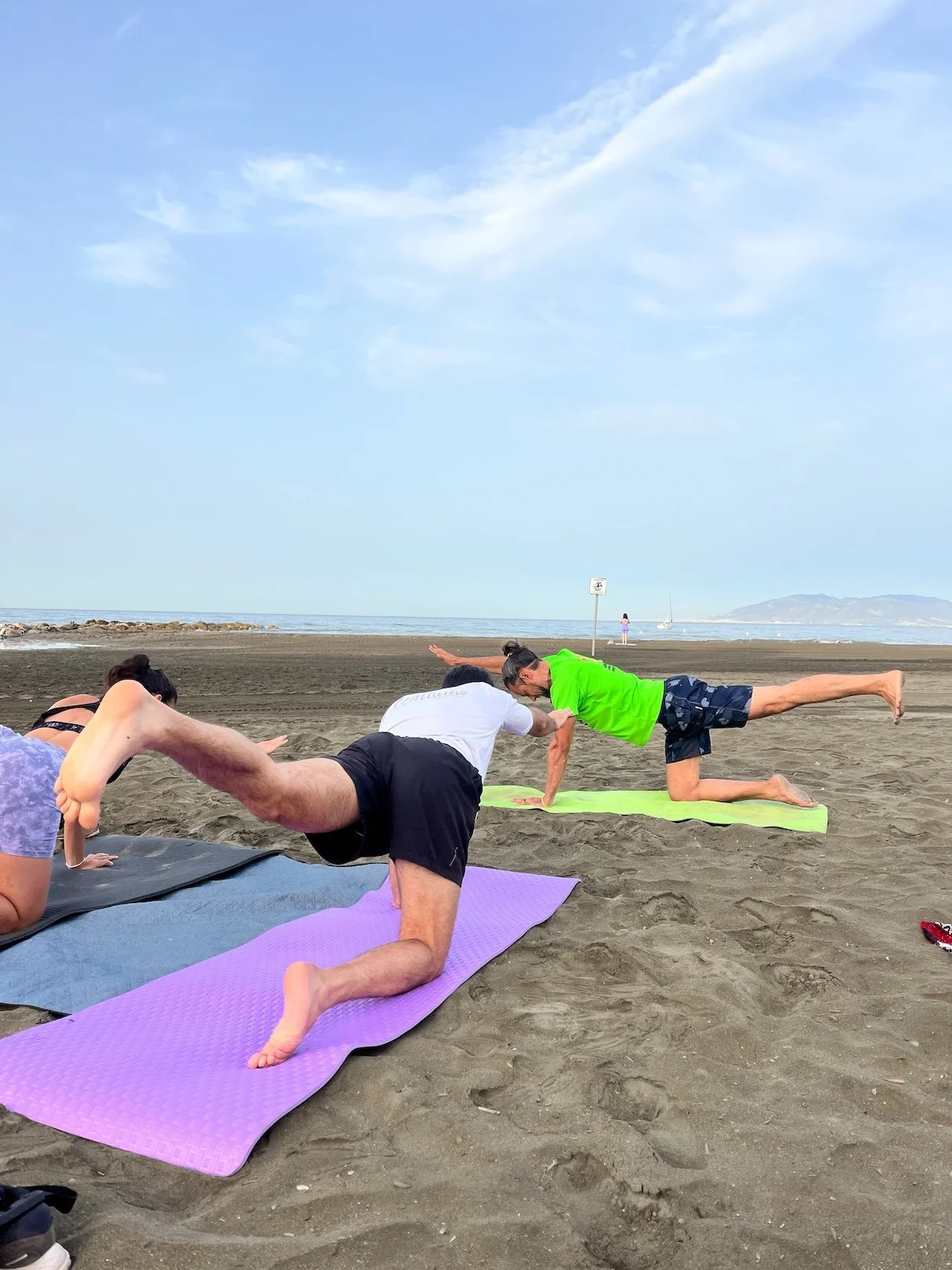 Bird dog pose during beach yoga.jpg