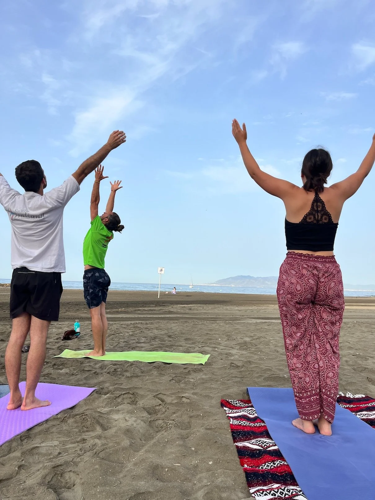 Sun salutations during beach yoga.jpg