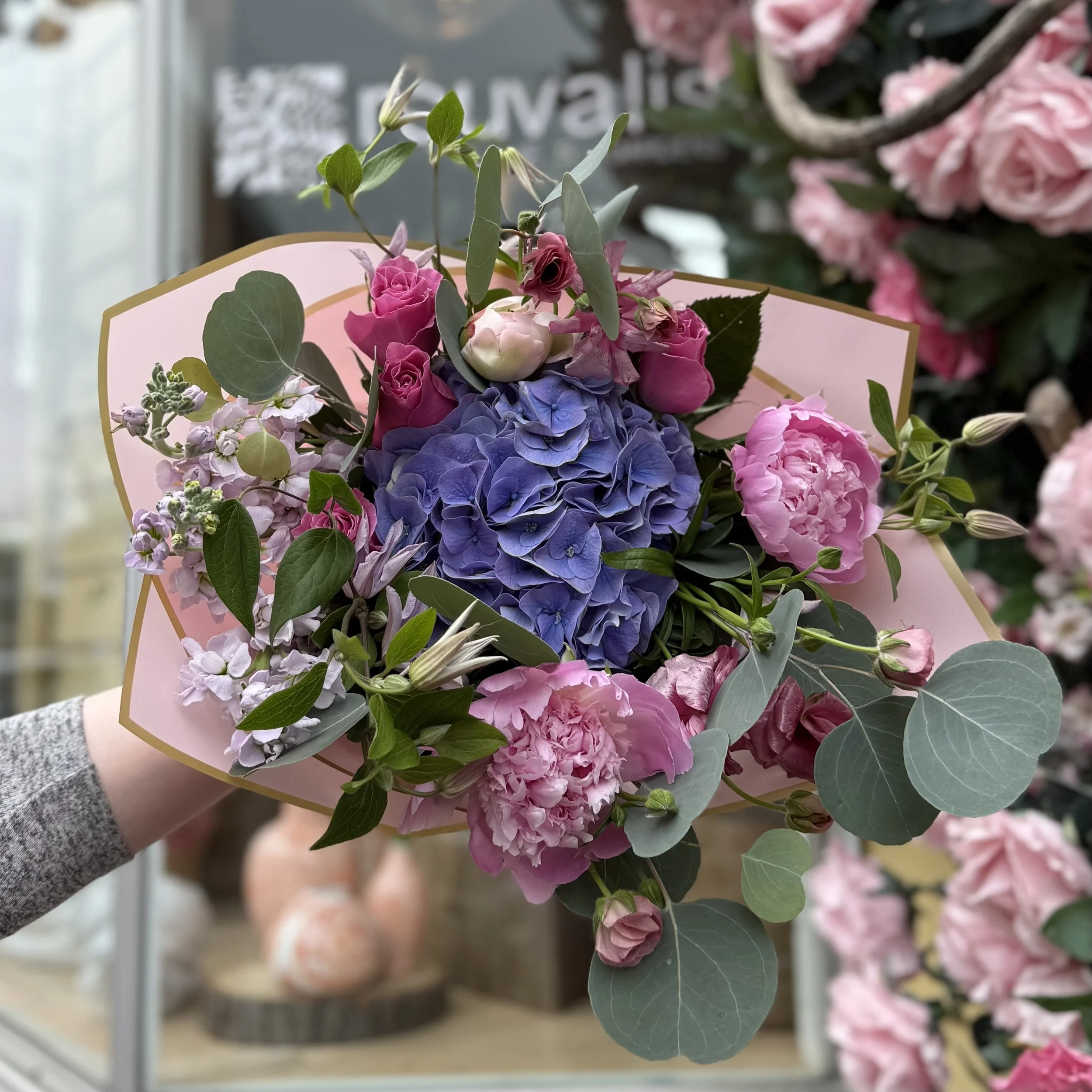 florist with mothers day bouquet pickup