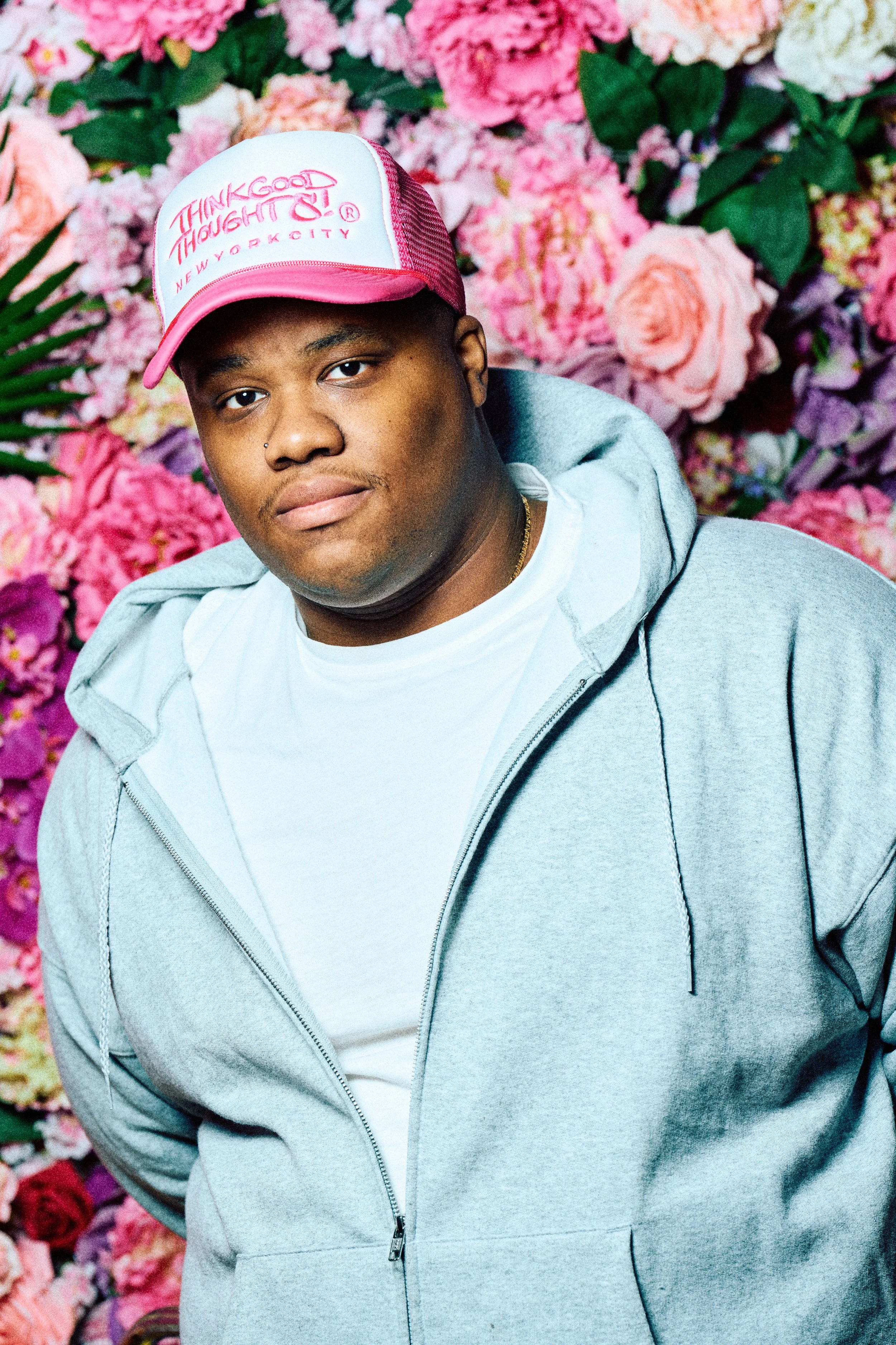 Khris Black looking adorable in front of a flower wall. Photo by Harry Aaron.