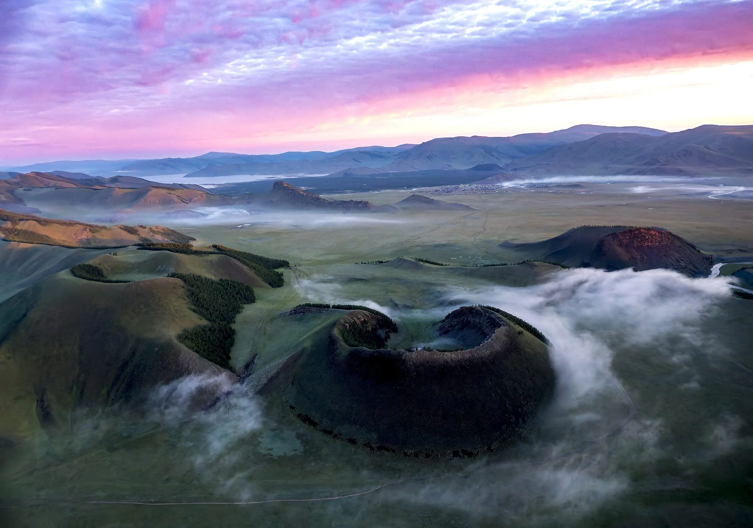 Three volcanic craters above morning cloud near Khorgo volcano, Mongolia