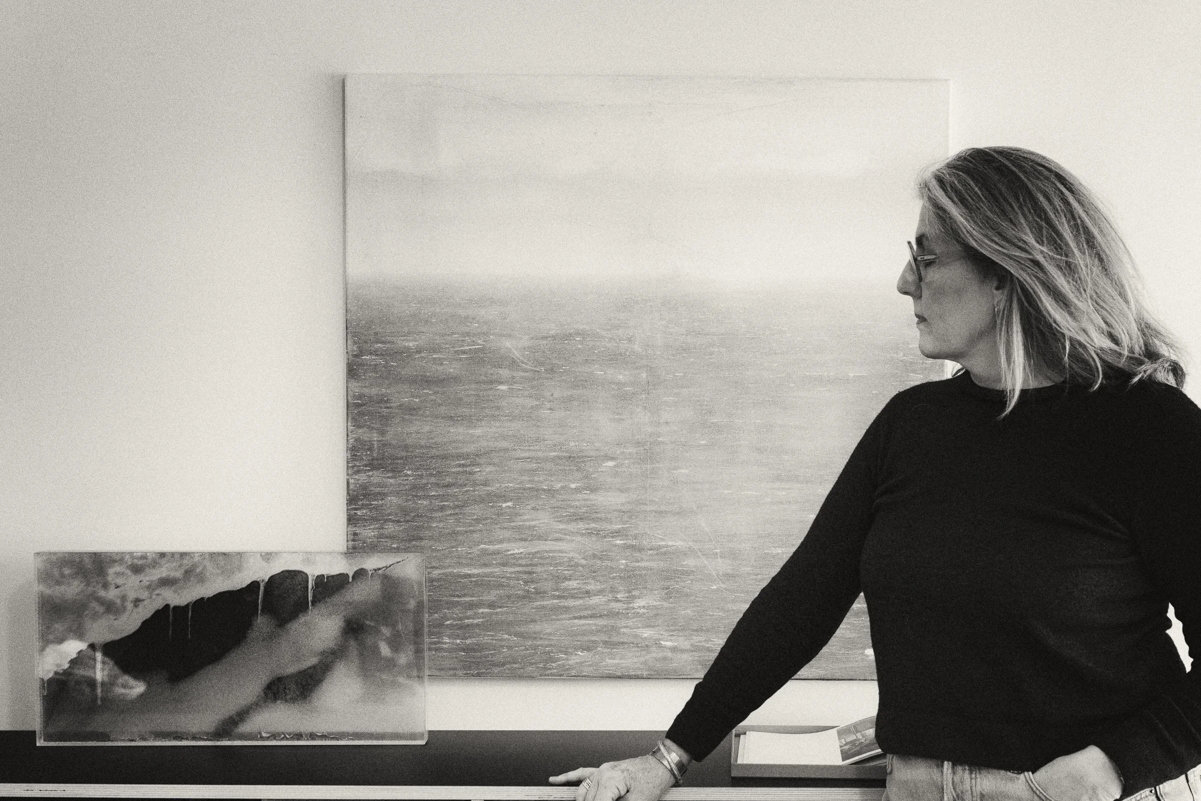Portrait of Dutch visual artist Margaret Lansink with her mixed-media artworks in her studio.